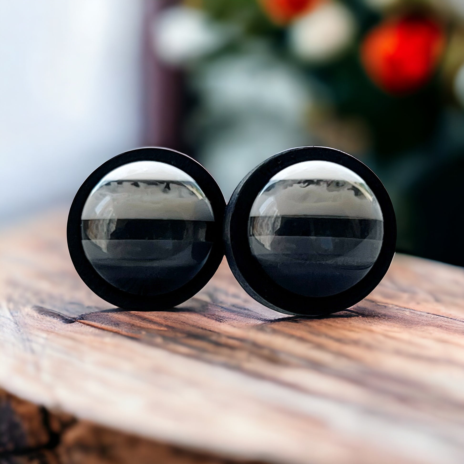 Close-up of 12mm striped resin earrings in wood bezel