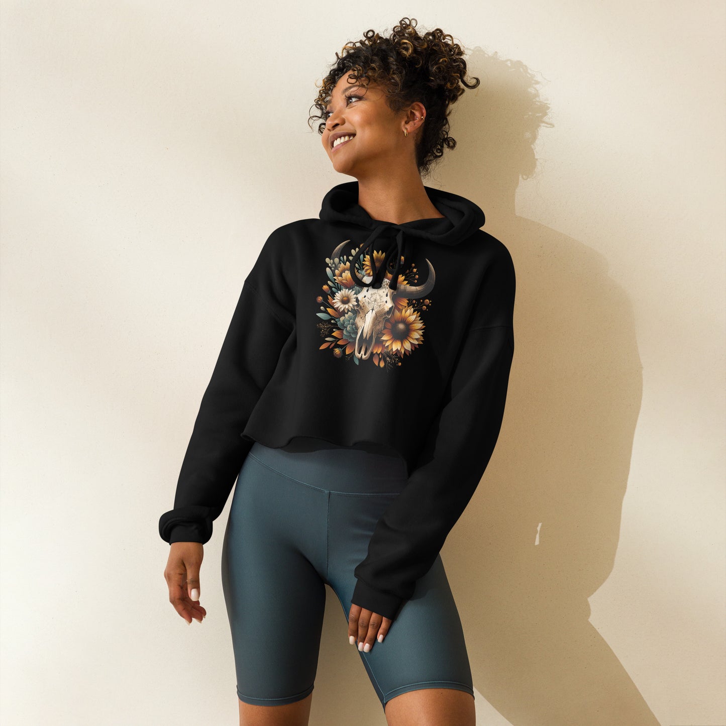 Side view of black hoodie with rustic floral skull and earthy details