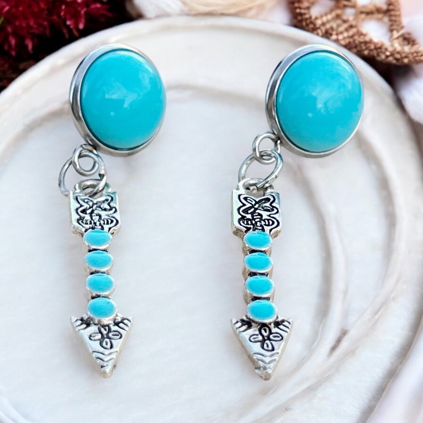 Turquoise Arrow Earrings – Handmade Boho Western Dangles on decorative tray