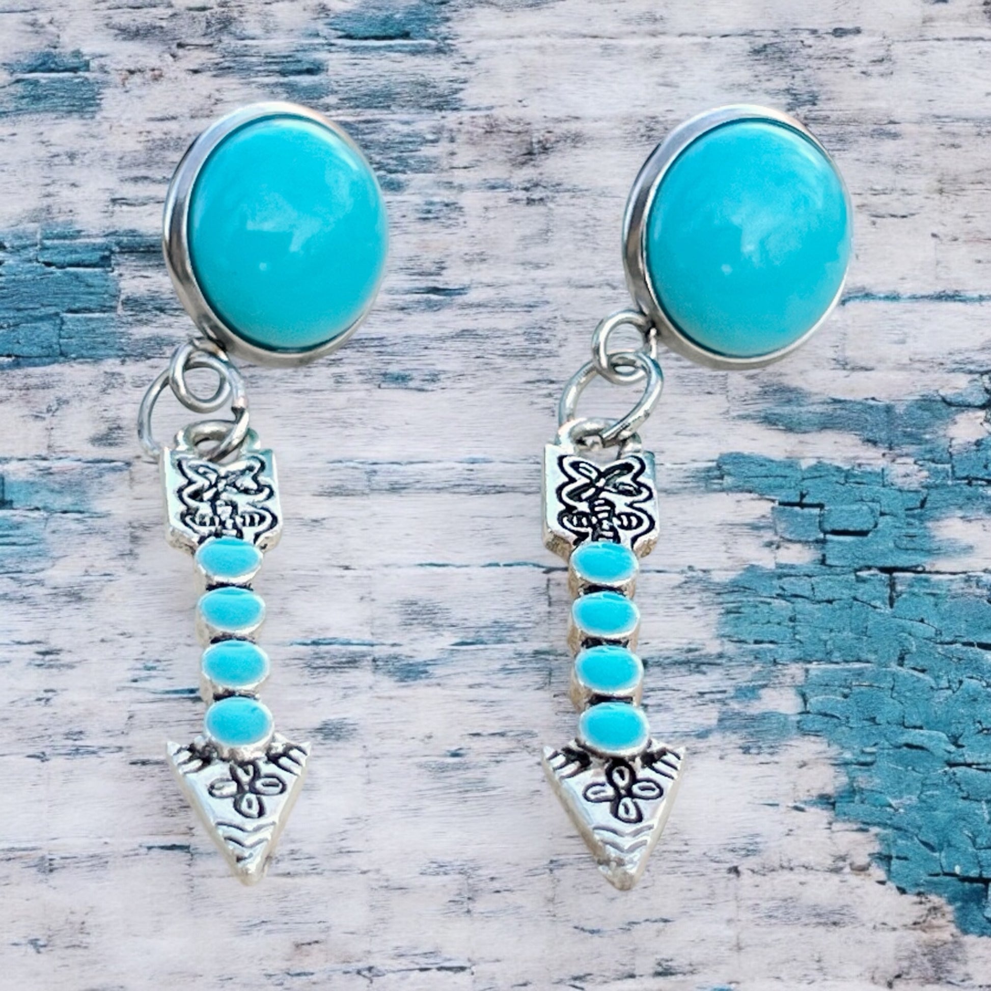 Turquoise Arrow Earrings – Handmade Boho Western Dangles on textured wood background 