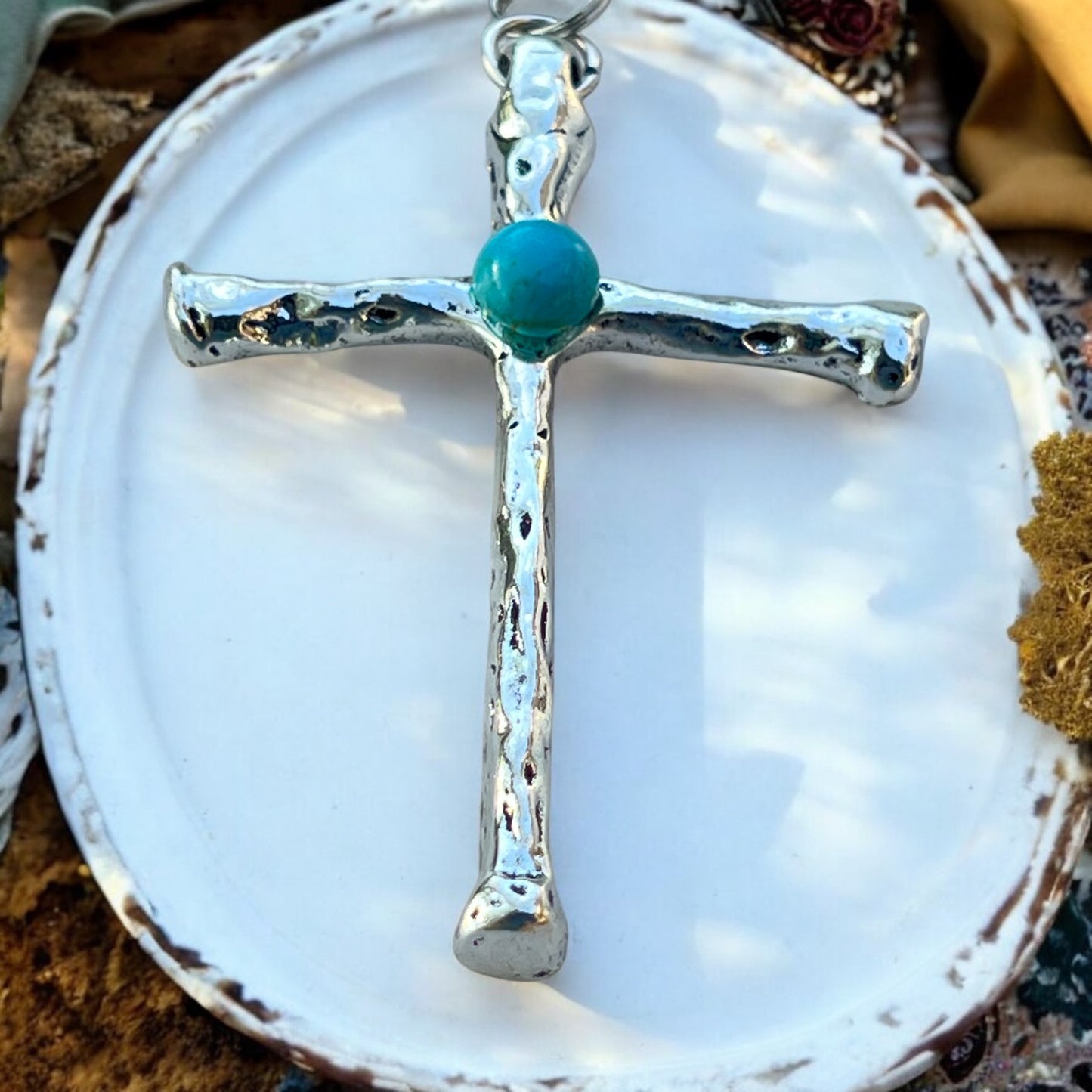 Front view of turquoise cross purse charm with rustic silver finish
