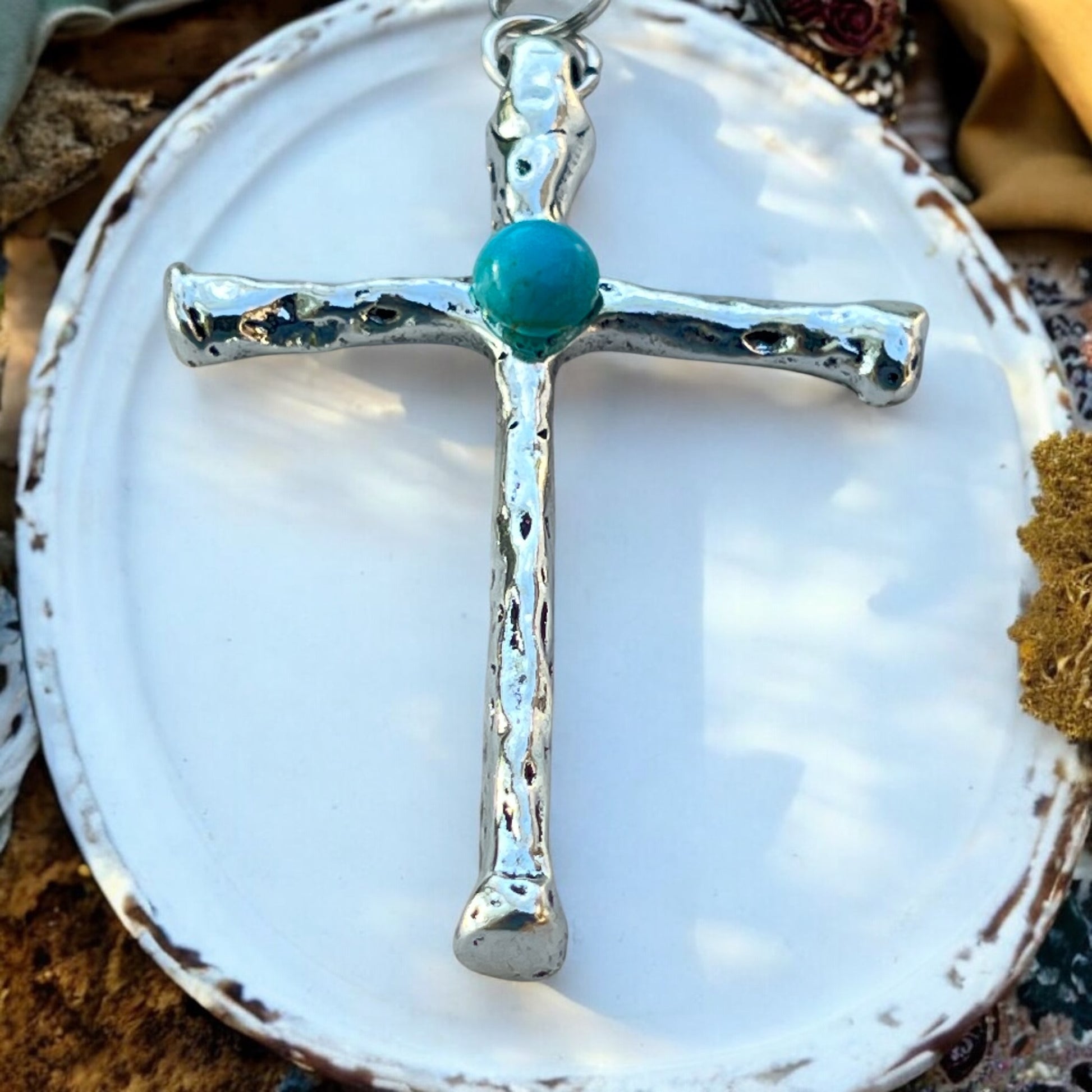 Front view of turquoise cross purse charm with rustic silver finish