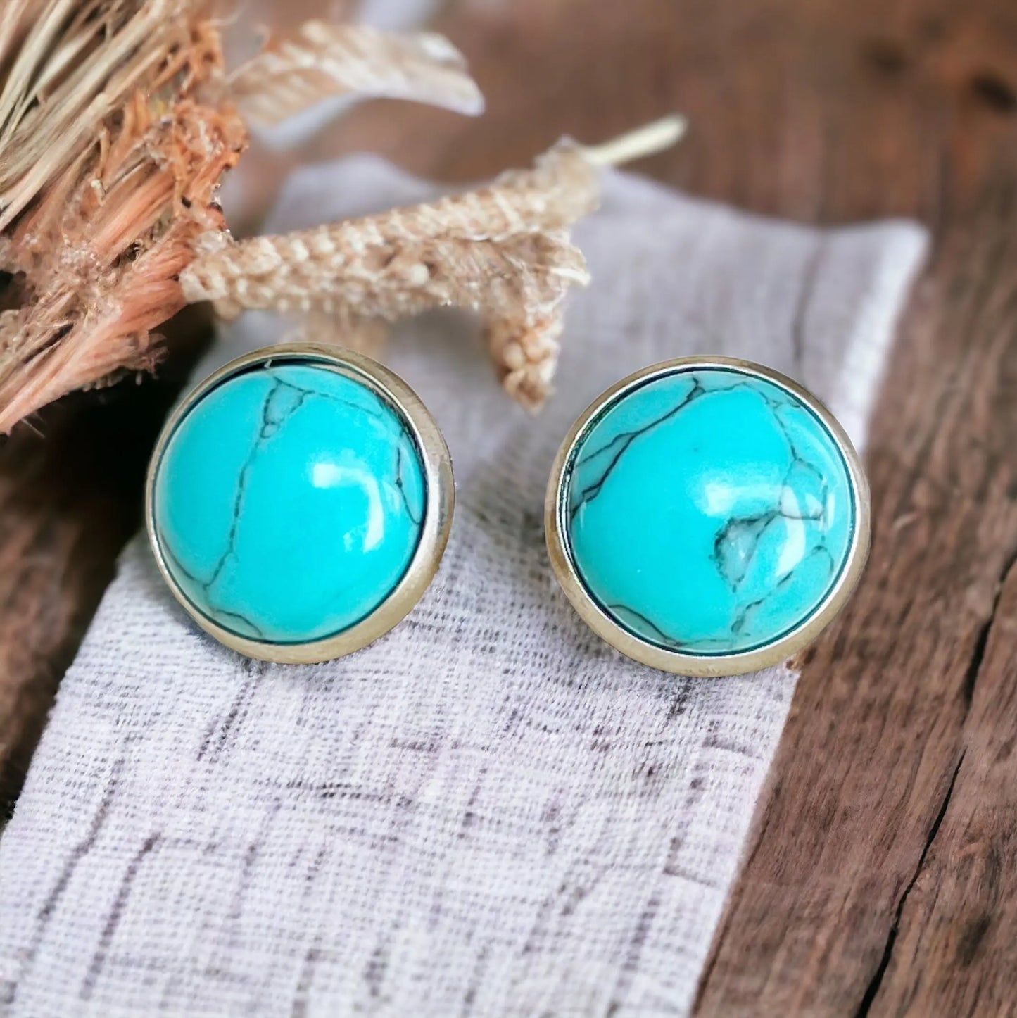 Turquoise 12mm Silver Stud Earrings on decorative wooden display 