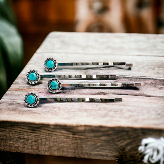 Flat lay of turquoise western hair pins in a set of four on neutral background
