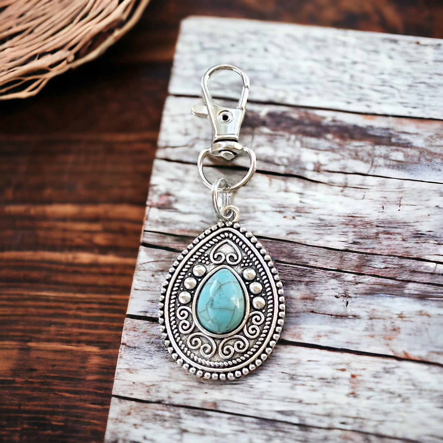 Western handbag charm with ornate medallion detail and faux turquoise accent on a styled wood display