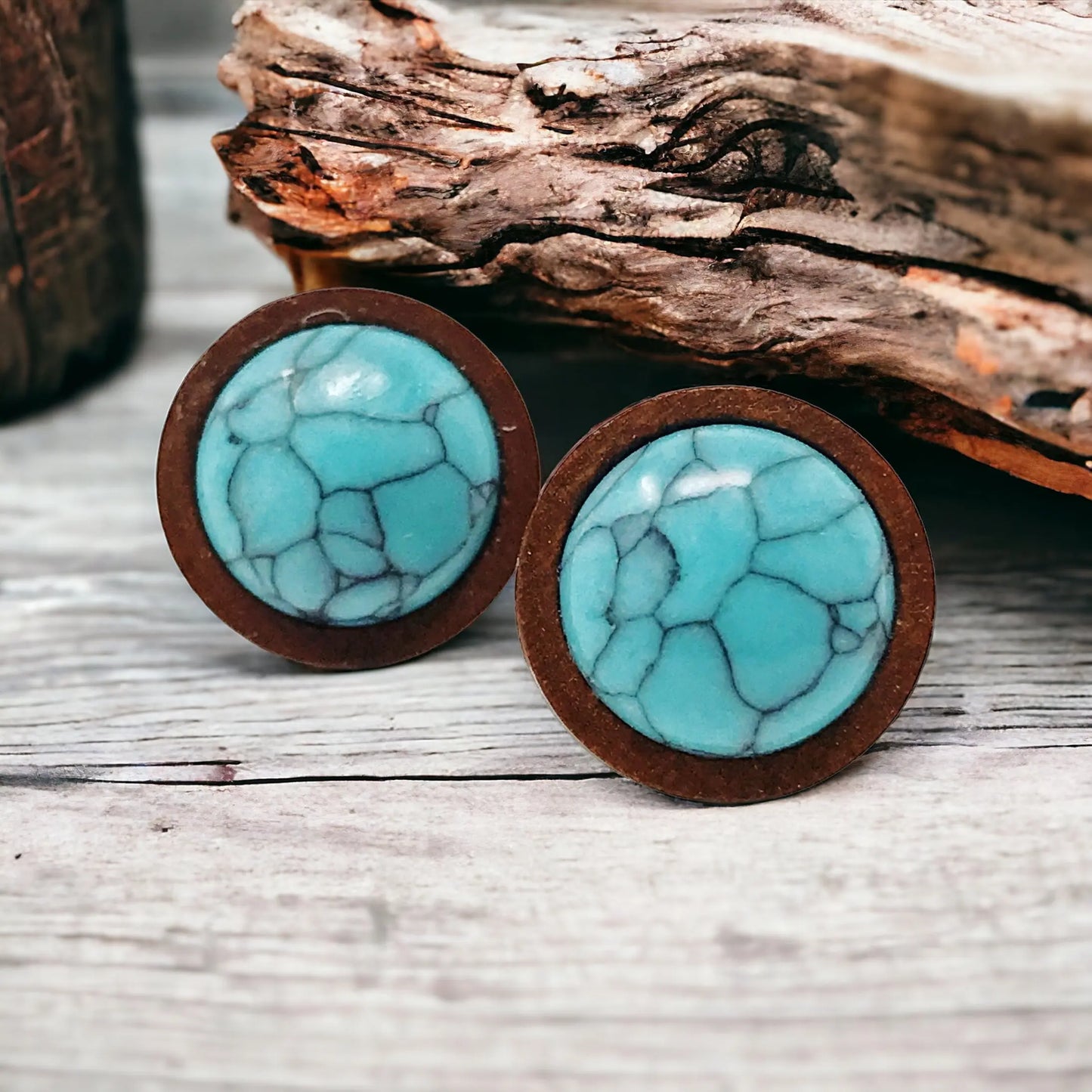 Round Boho turquoise wood stud earrings displayed on a rustic wood surface