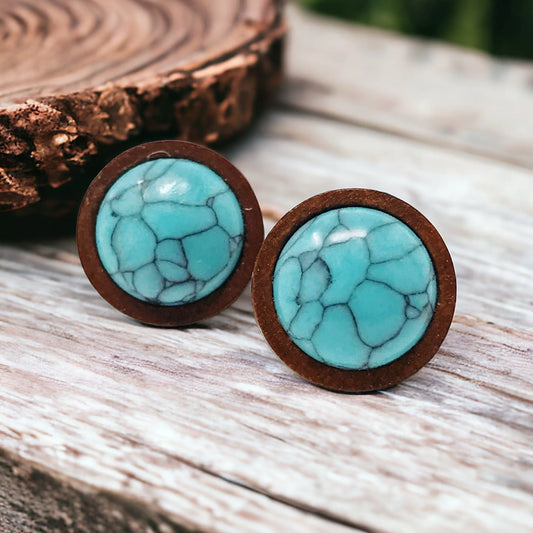 Round western turquoise wood stud earrings displayed on a rustic wood surface