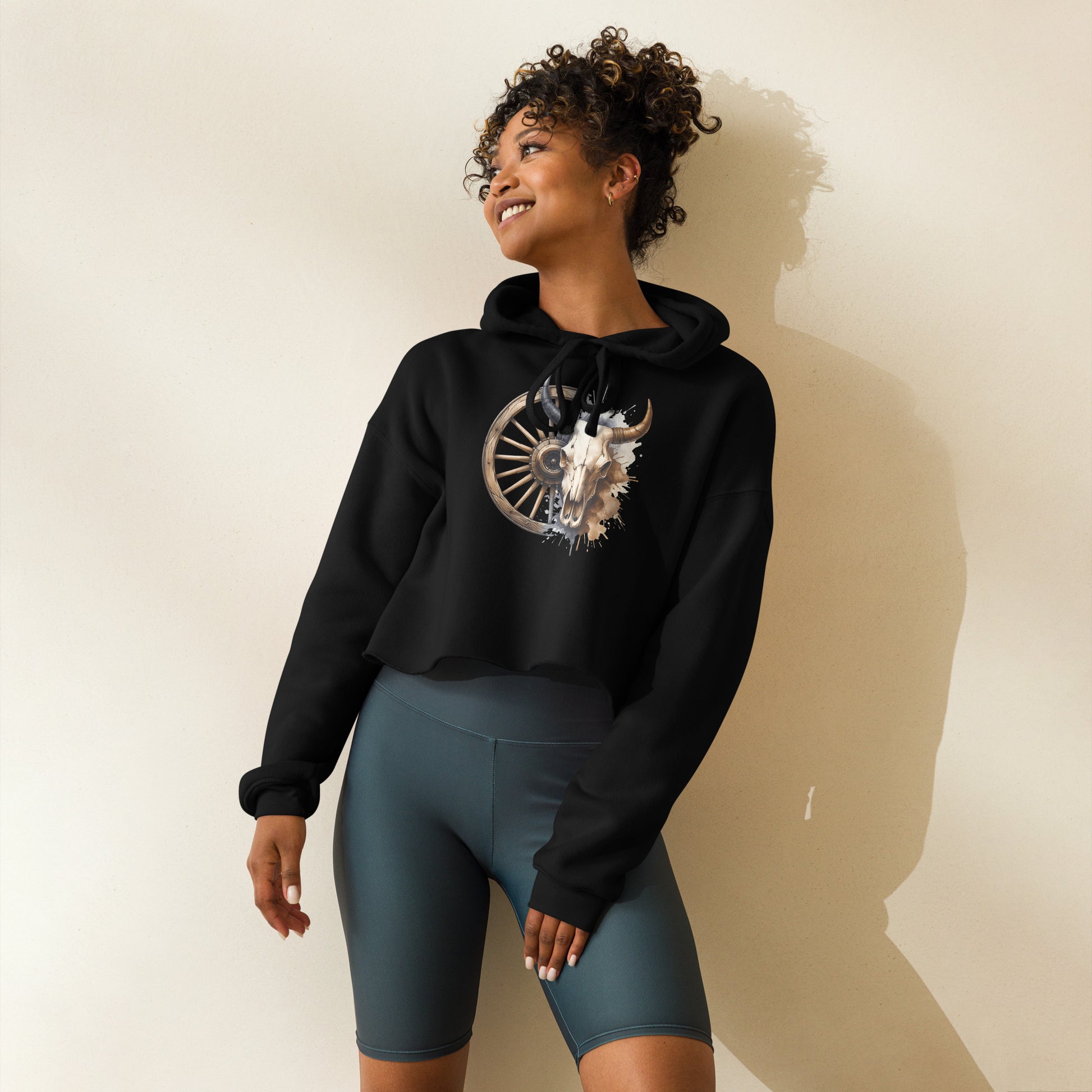 Side view of black hoodie with rustic bull skull and western wagon wheel design