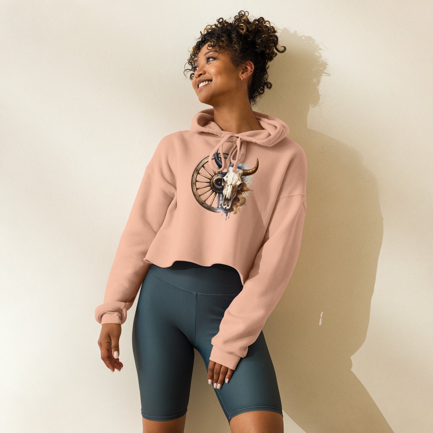 Peach western hoodie with bull skull and wagon wheel graphic – front view