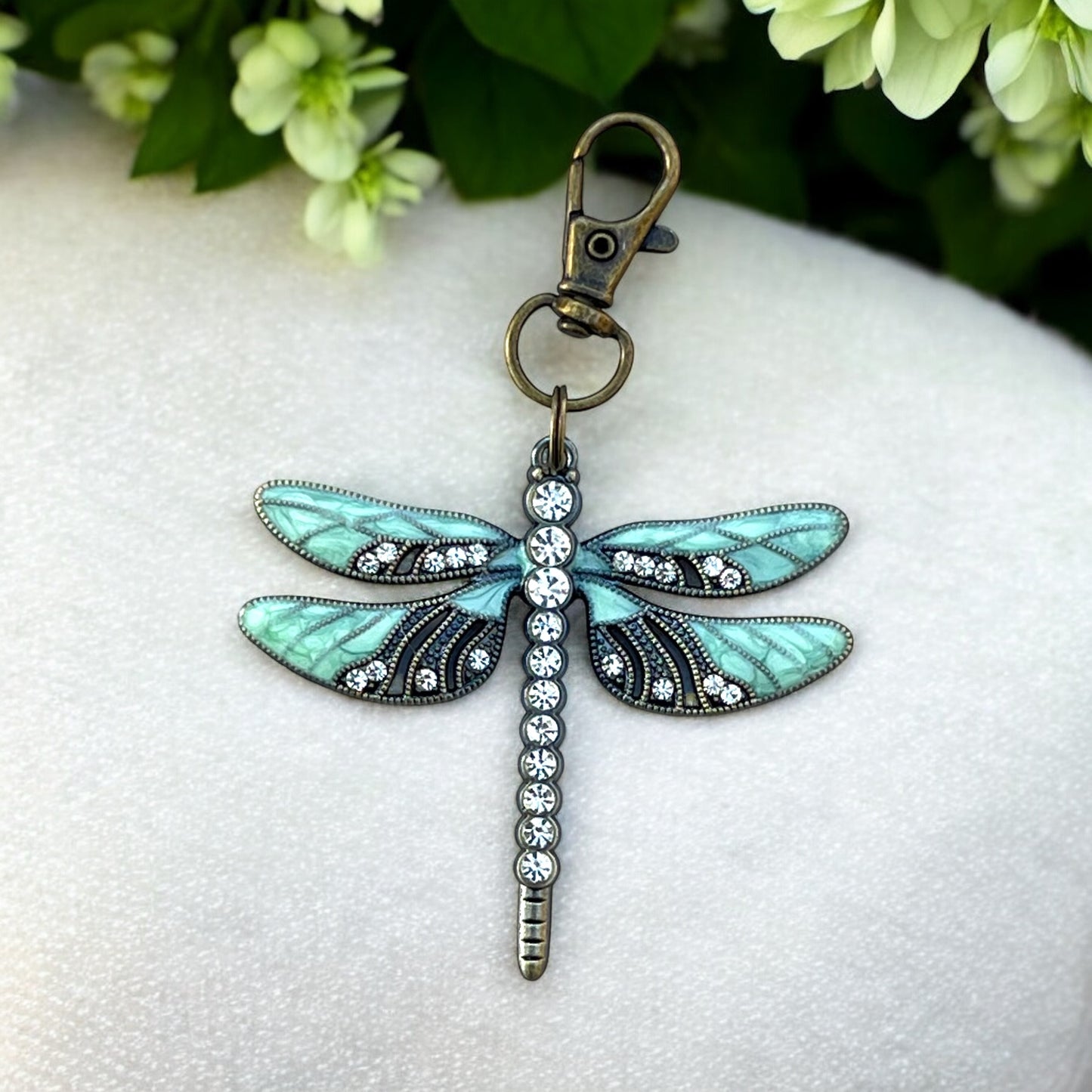 Whimsical dragonfly bag charm in mint, black, and clear rhinestones