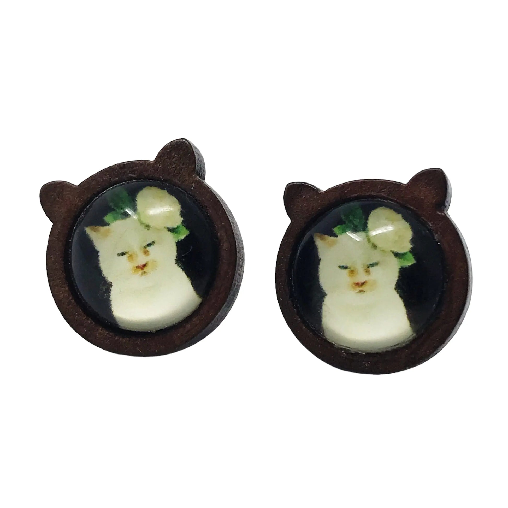 Cat shaped wood stud earrings with white cat artwork and floral detail on a white background