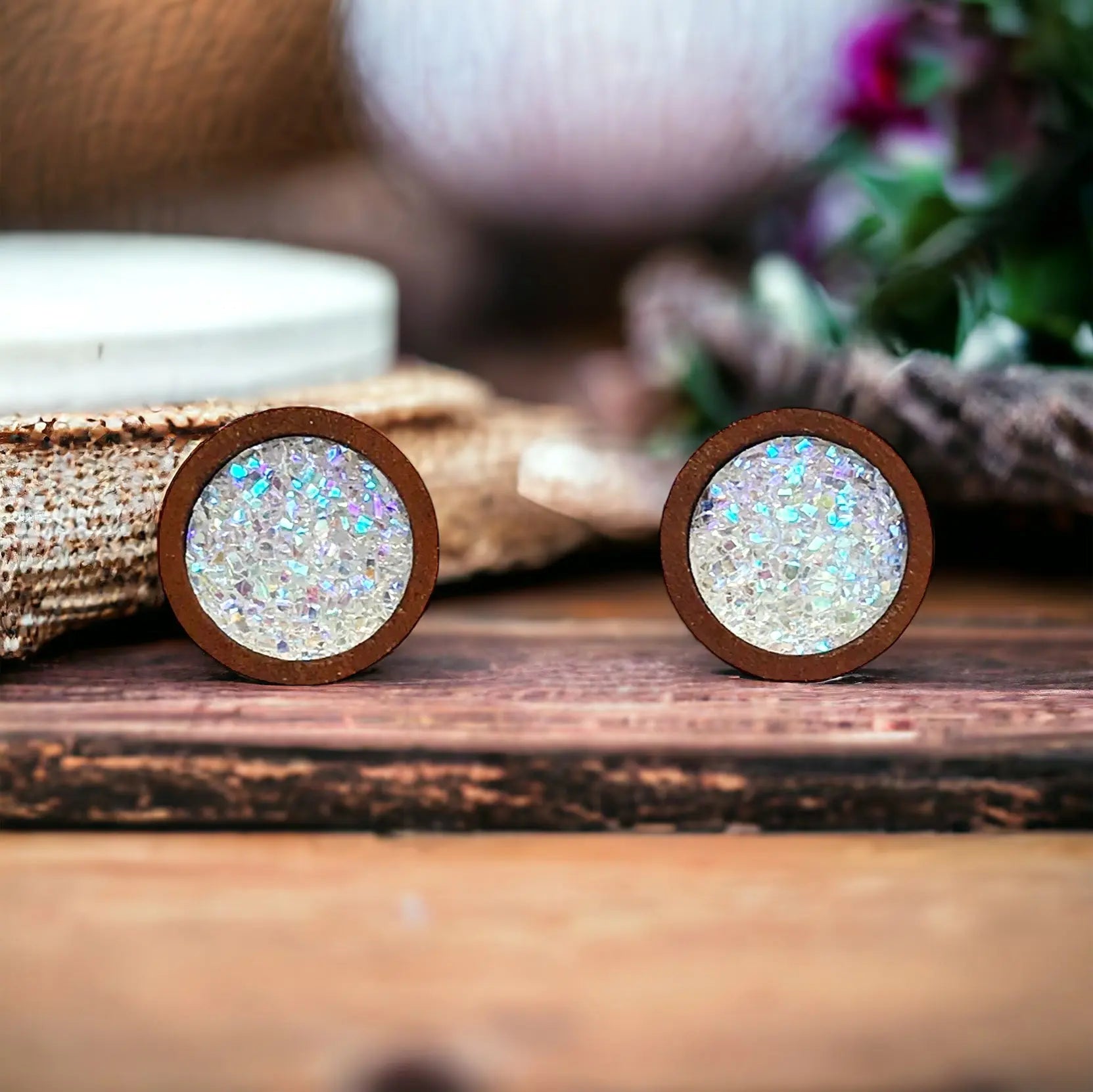 Round white glitter druzy wood stud earrings displayed on a wood surface