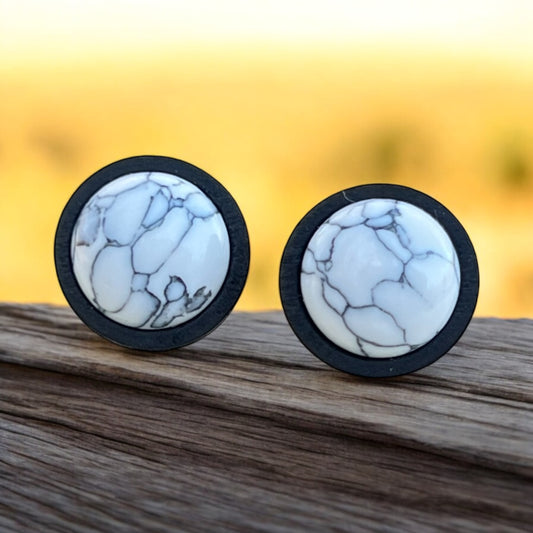 White stone stud earrings flat lay with gray veining and wood bezel