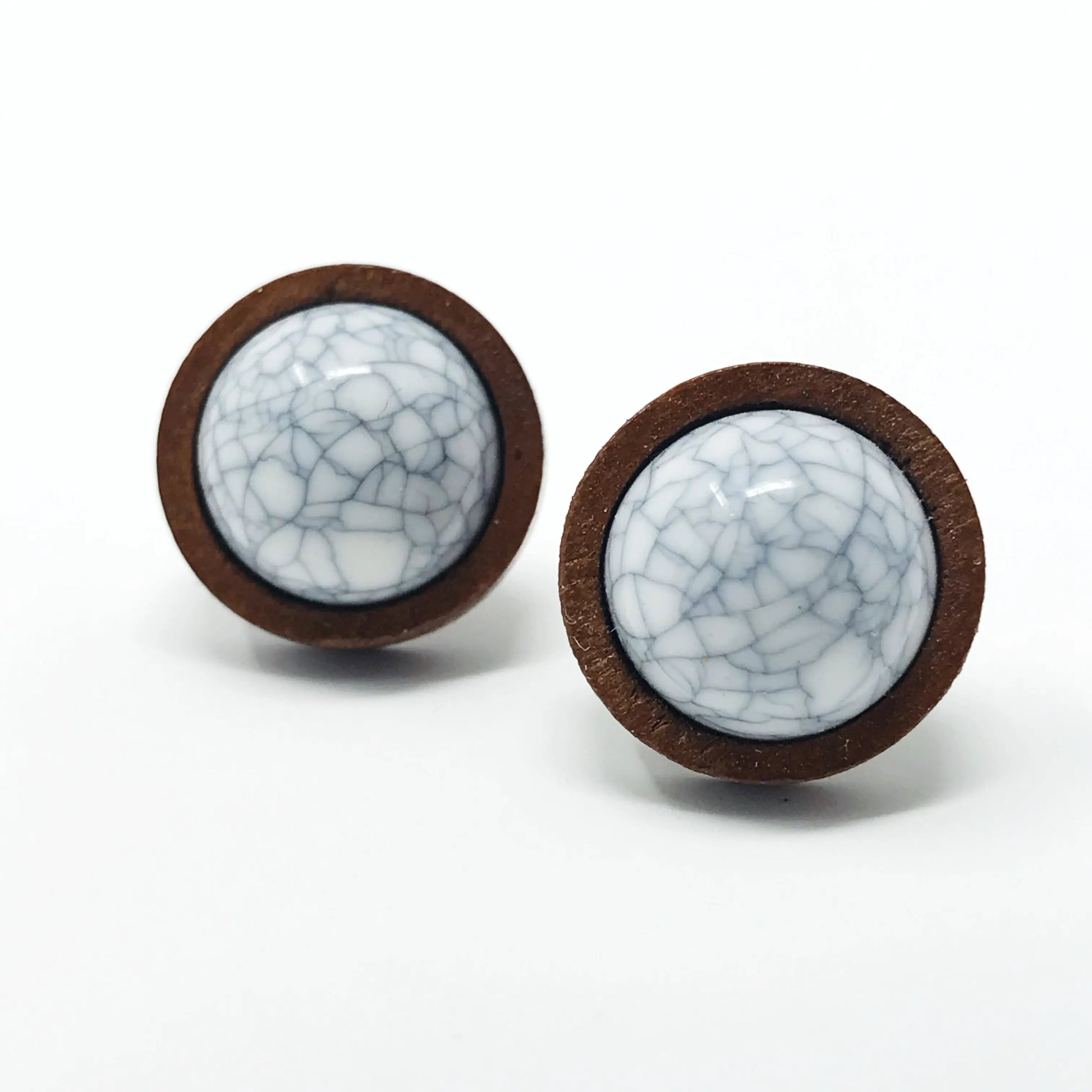 Round white marble wood stud earrings displayed on a white background