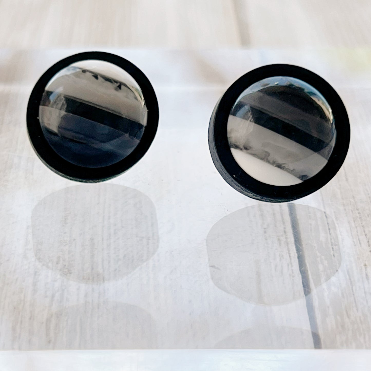 Black & White Striped Stud Earrings  on reflective mirror