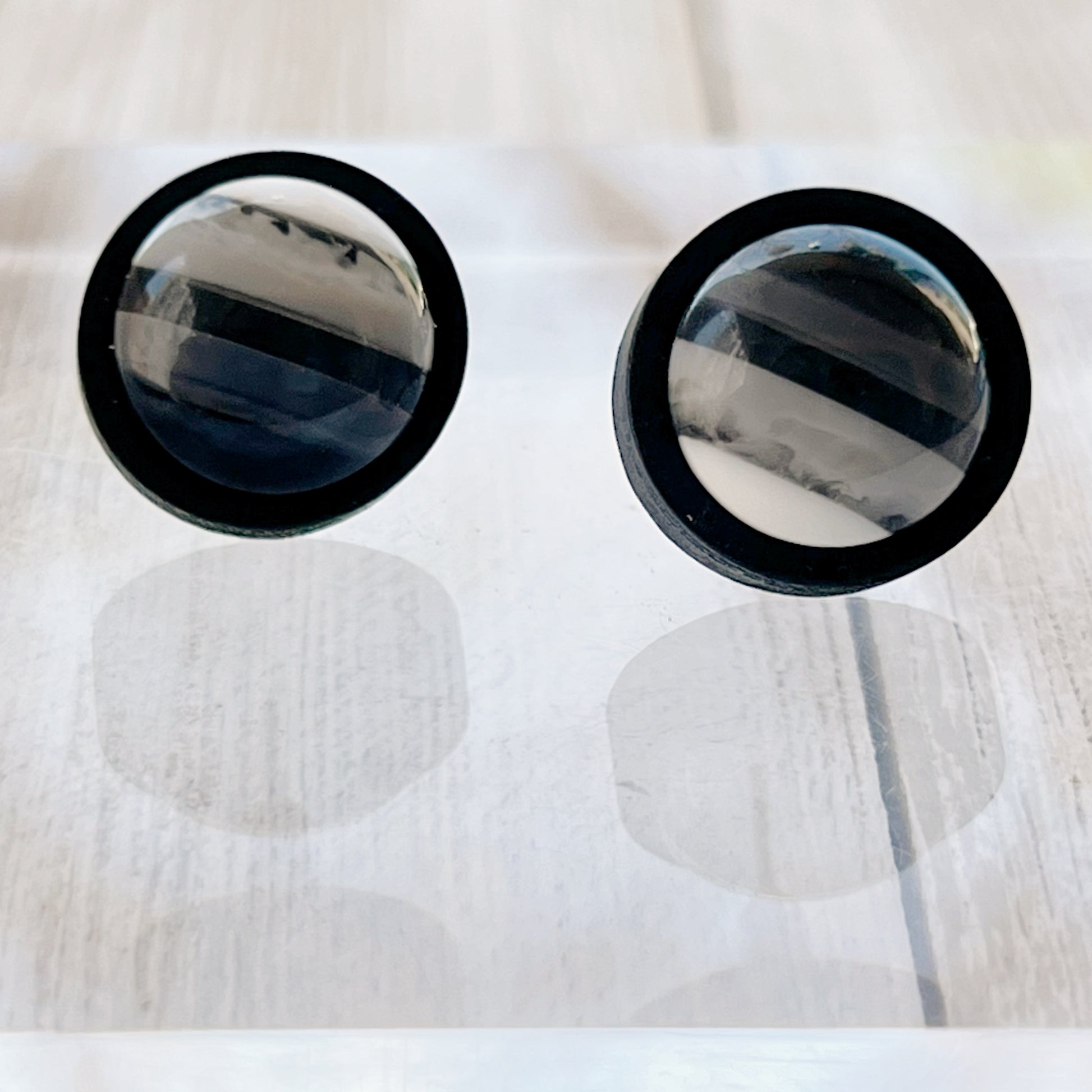 Black & White Striped Stud Earrings  on reflective mirror