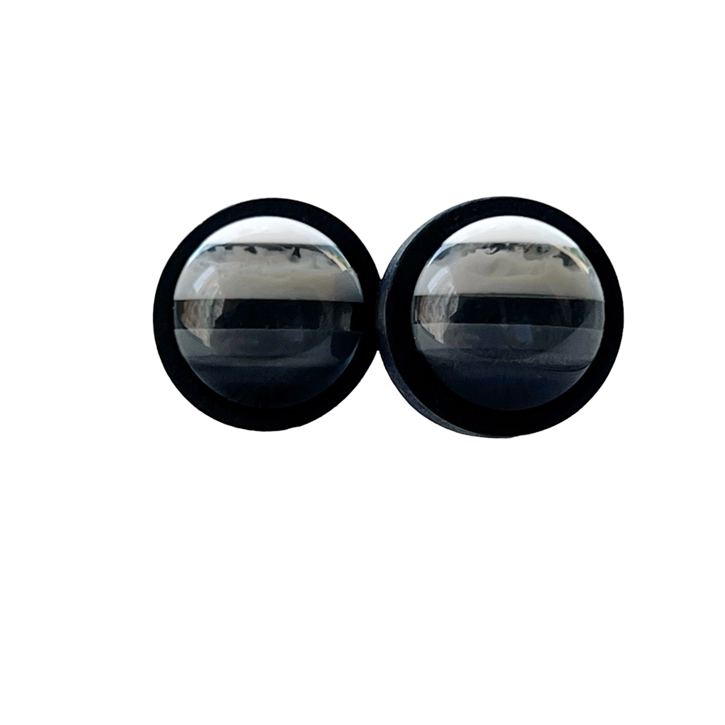 Black and white striped stud earrings on clean white background