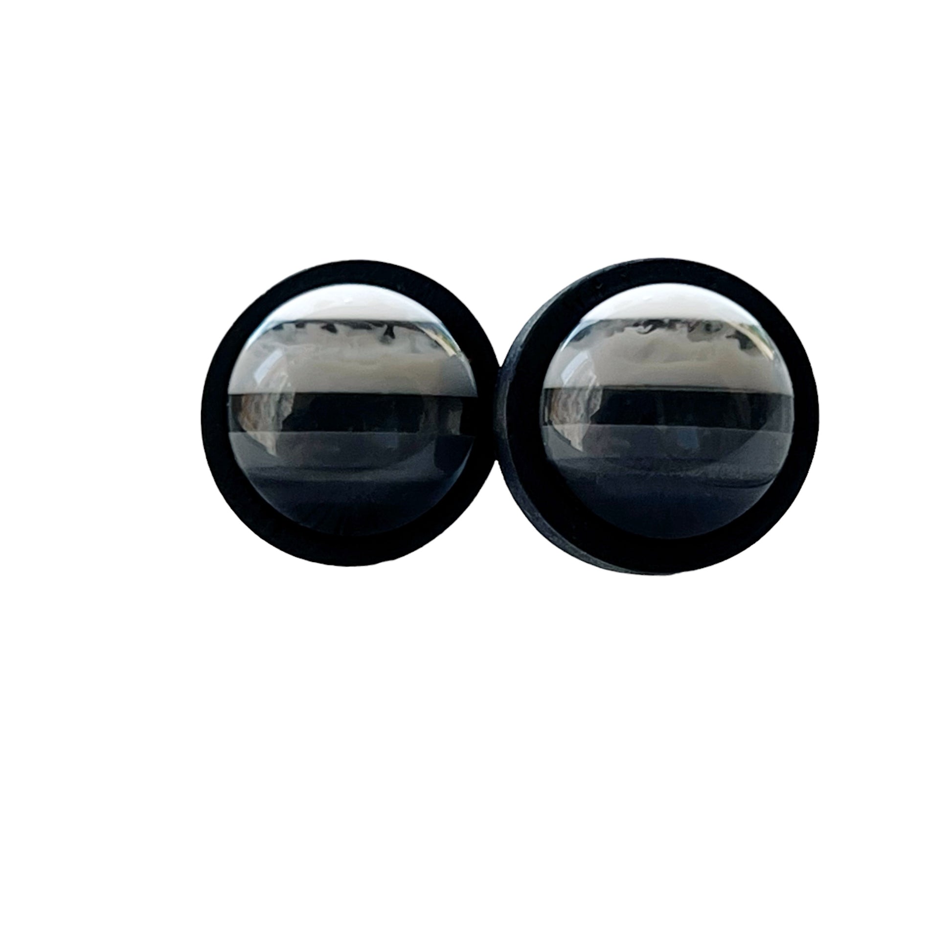 Black and white striped stud earrings on clean white background