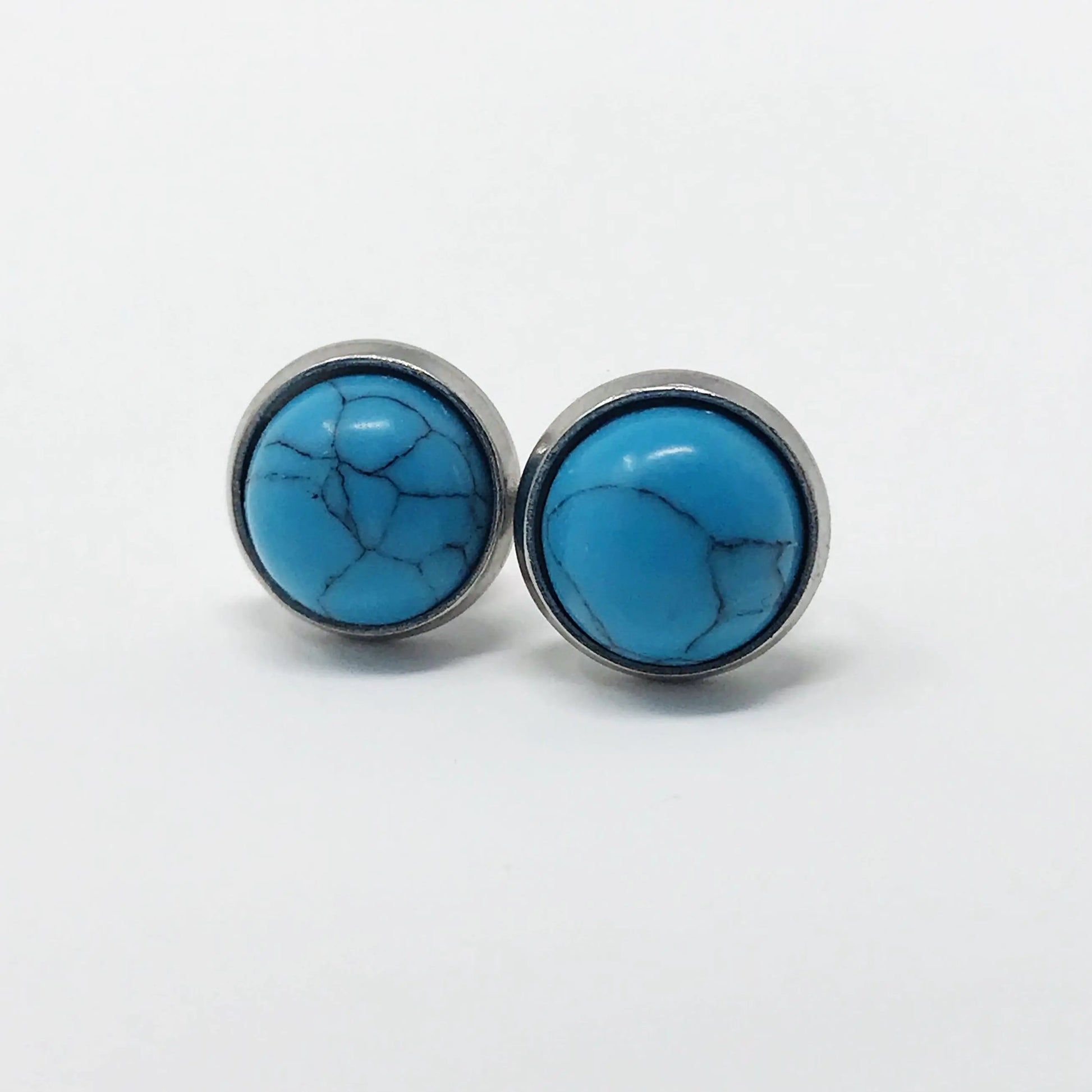 Round blue stone stud earrings in a silver-tone setting on a white background