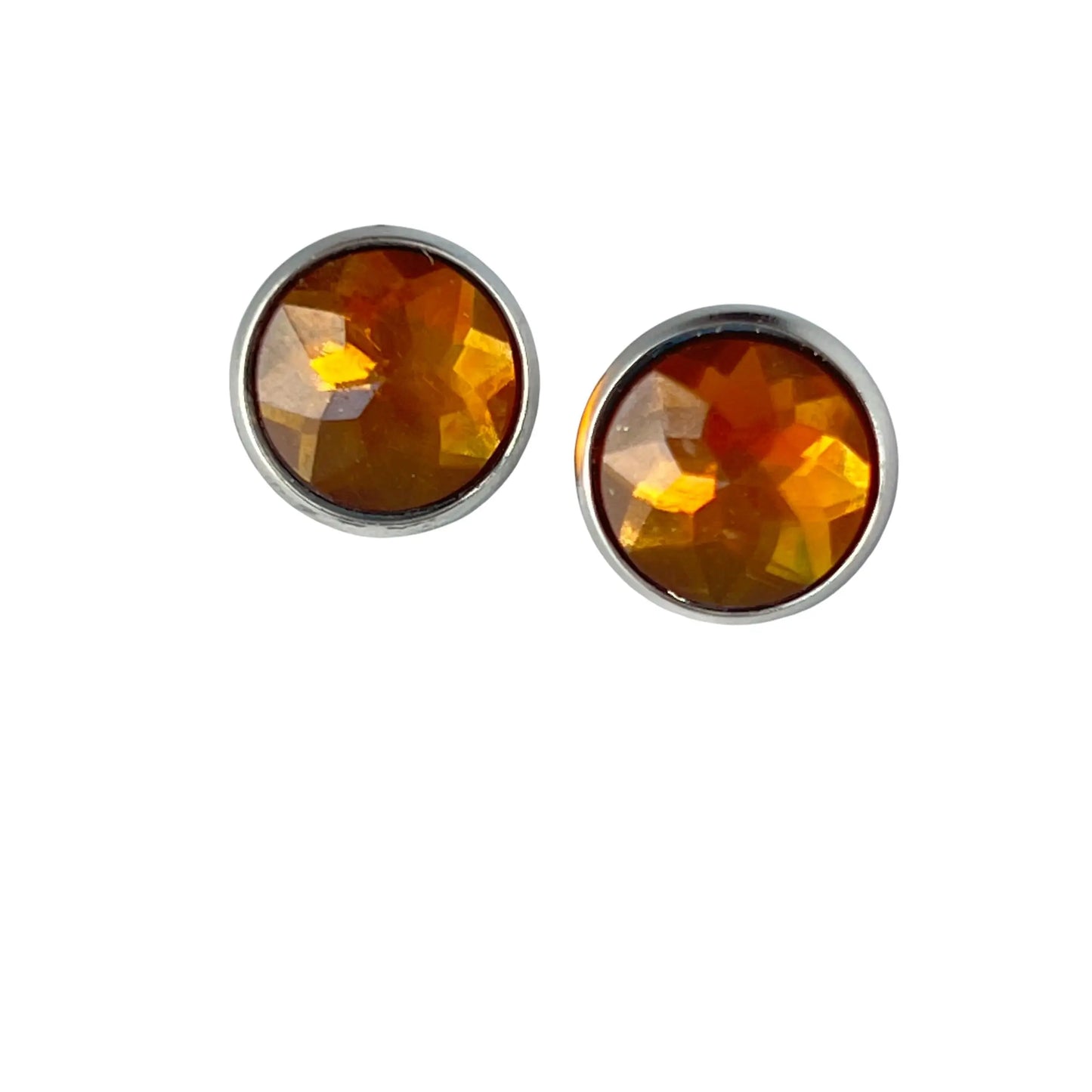 Pair of round amber-colored acrylic stud earrings on a white background