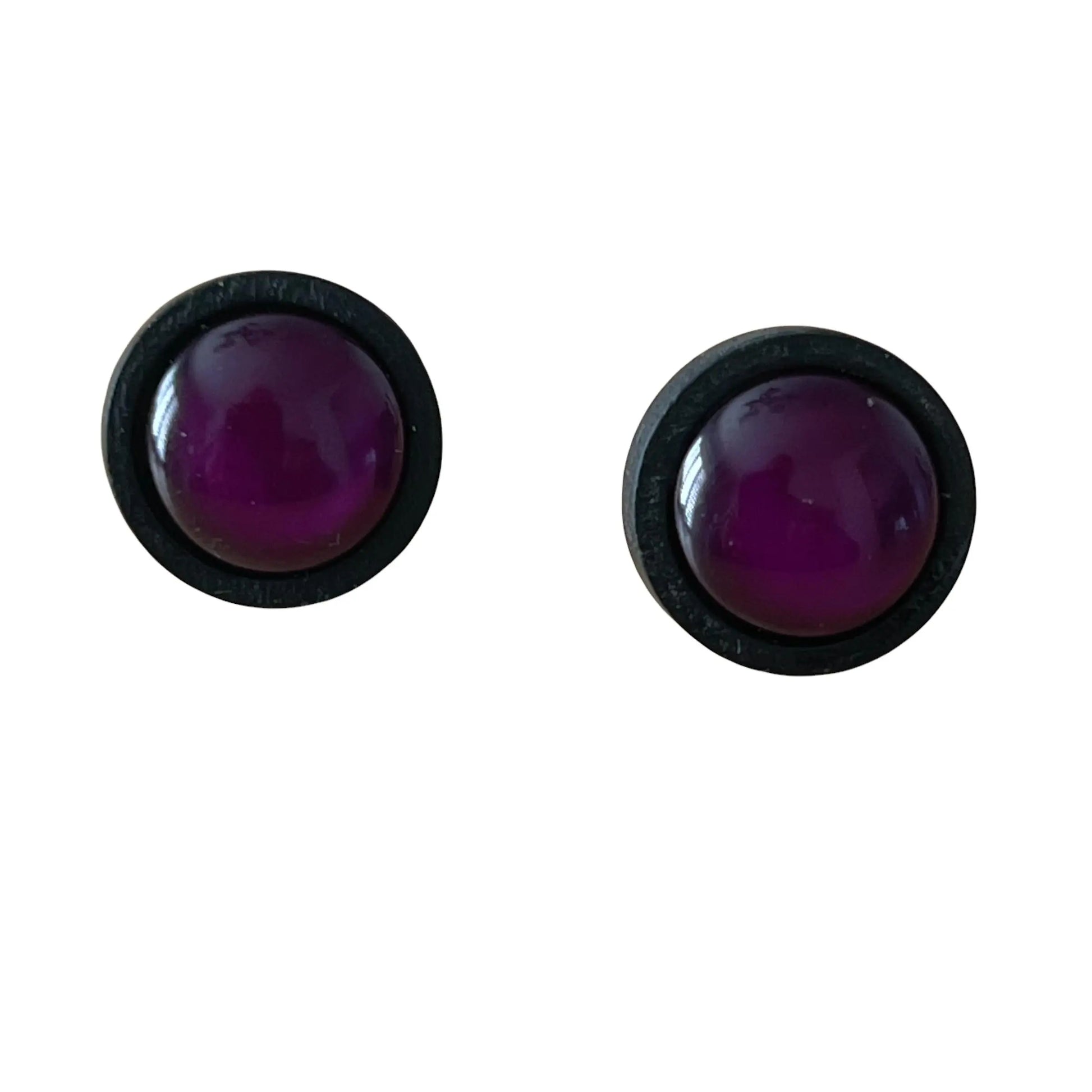 Pair of round purple earrings with black rims on a white background