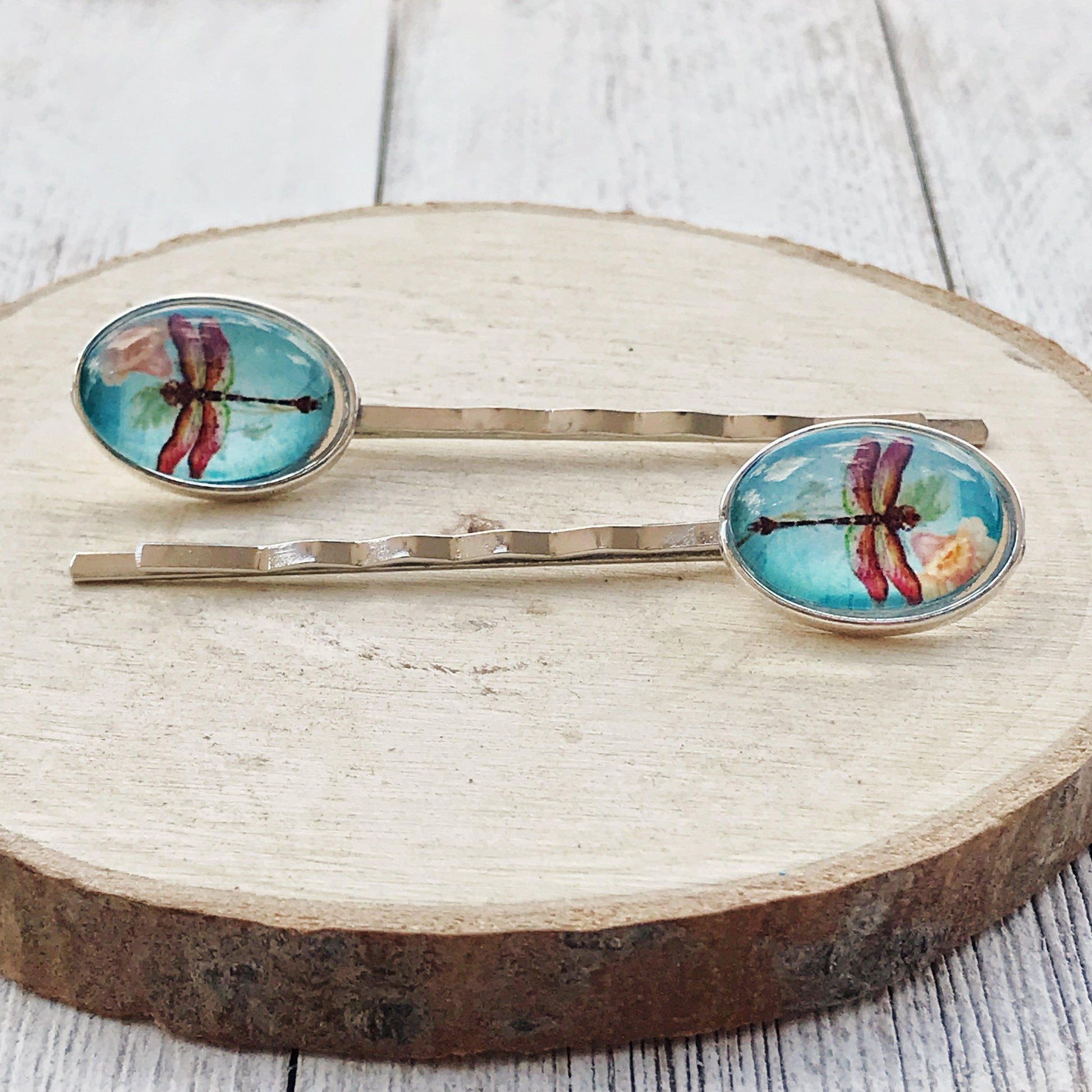 Close-up of gold dragonfly and flower embellishments on handmade hair pins