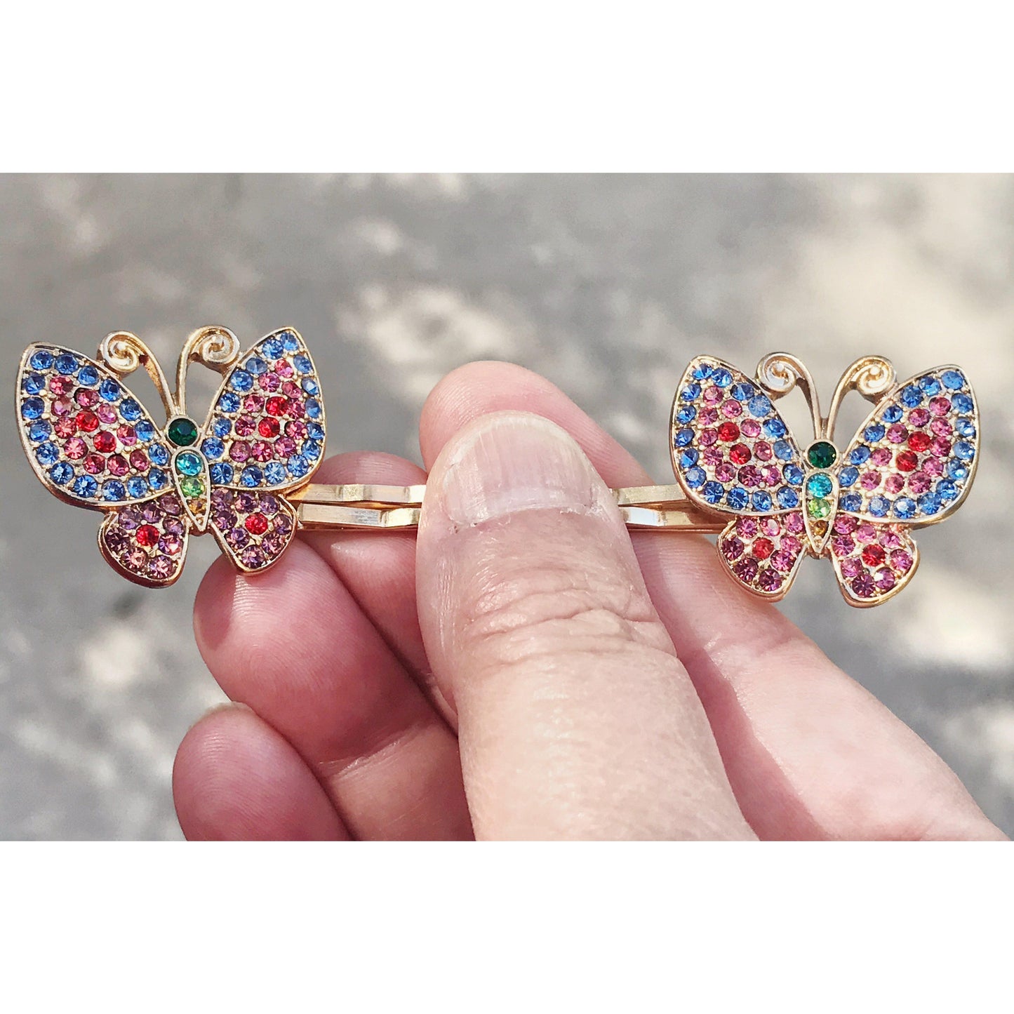 Set of multicolor rhinestone butterfly hair clips styled for gifting