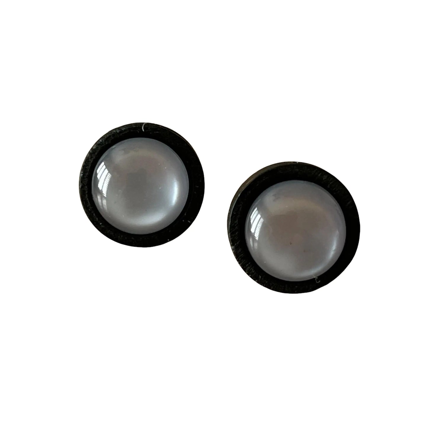 Two round gray earrings with black borders on a white background