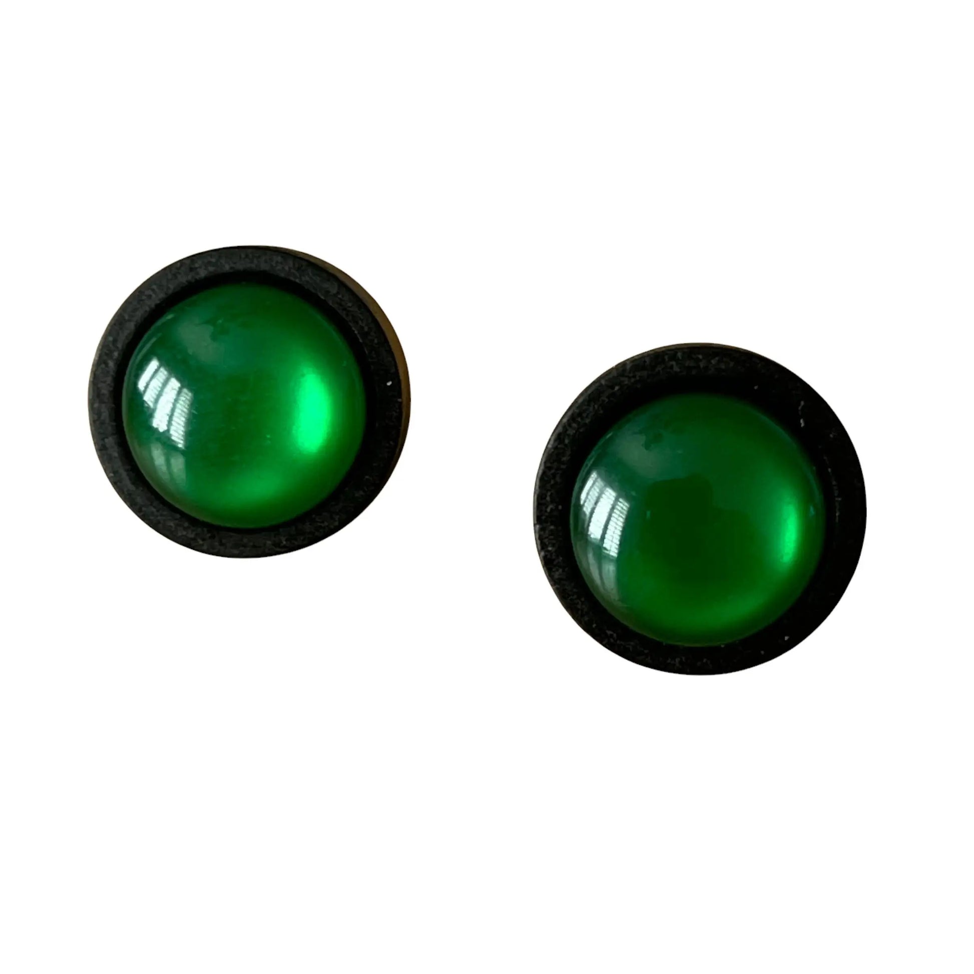 Pair of green round earrings with black frames on a white background