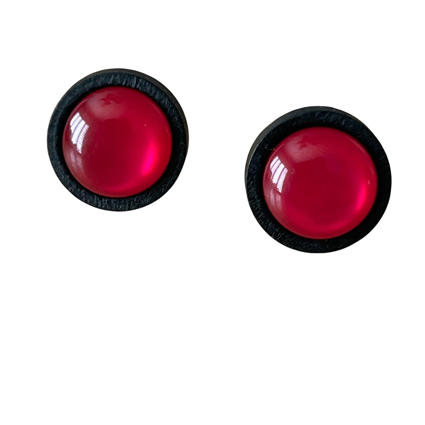 A pair of pink earrings with black borders on a white background