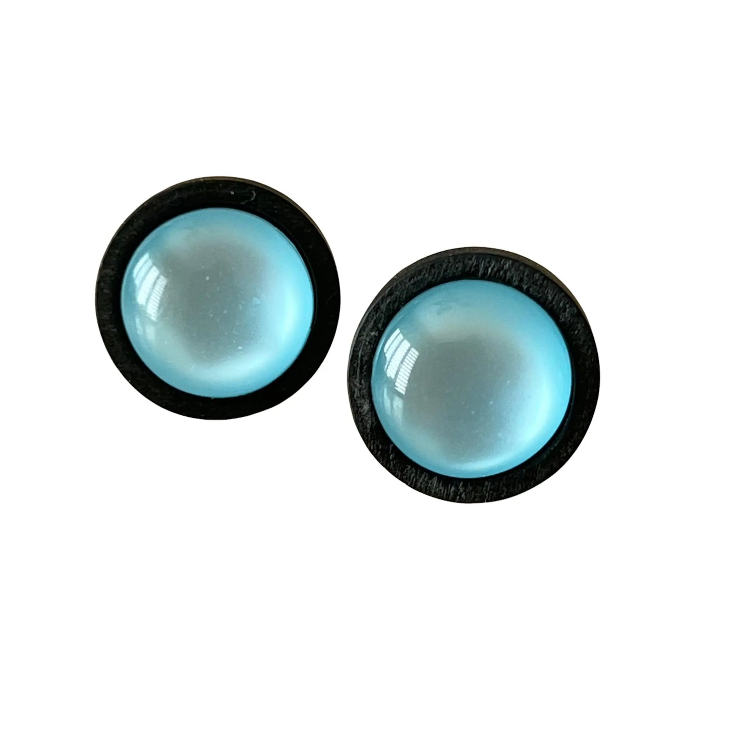Pair of round blue earrings with black frames on a white background