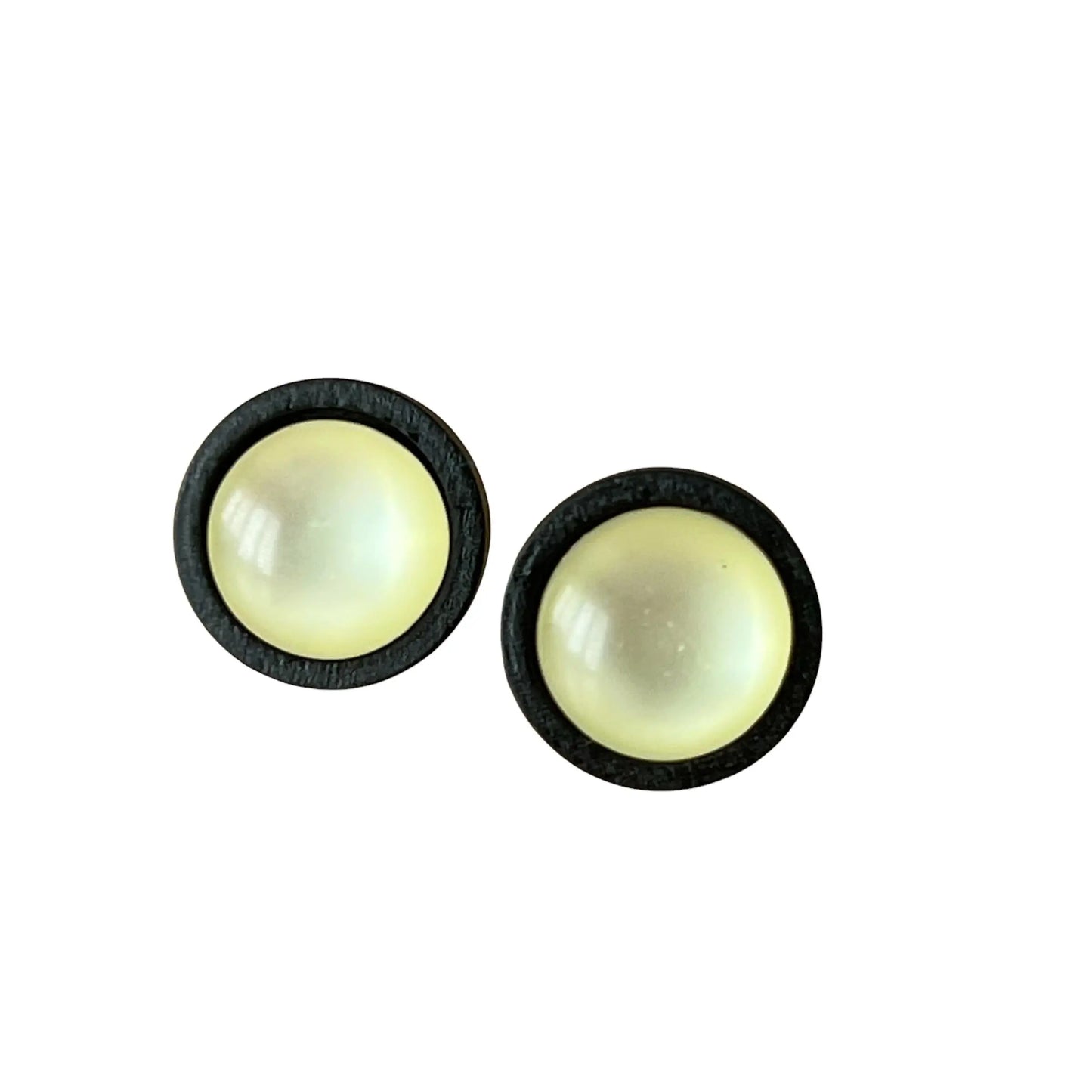 Pair of round earrings with a yellow center and black border on a white background