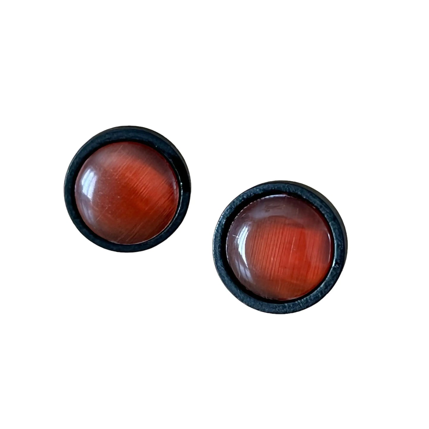 Round orange resin stud earrings with black wood borders displayed on a white background 