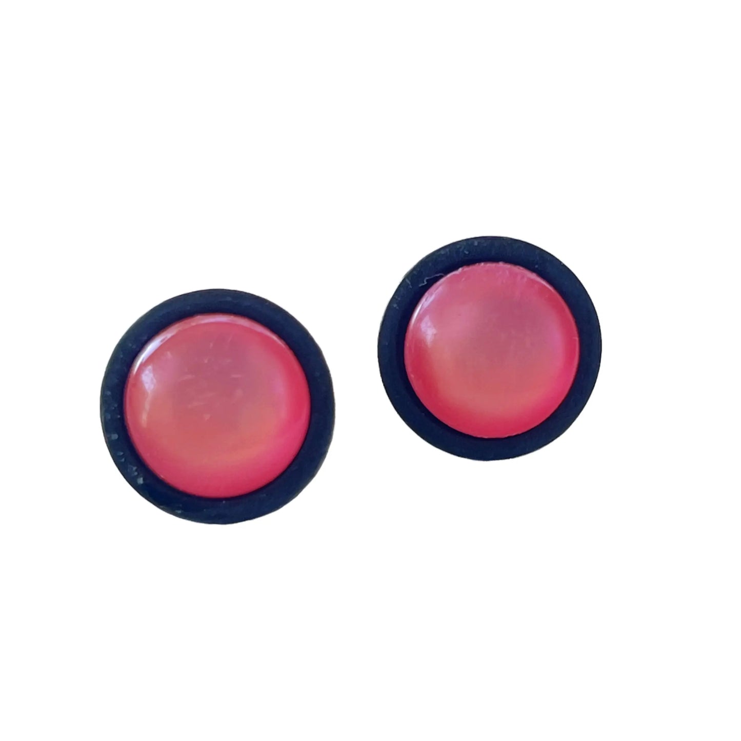 Pair of round pink earrings with black rims on a white background