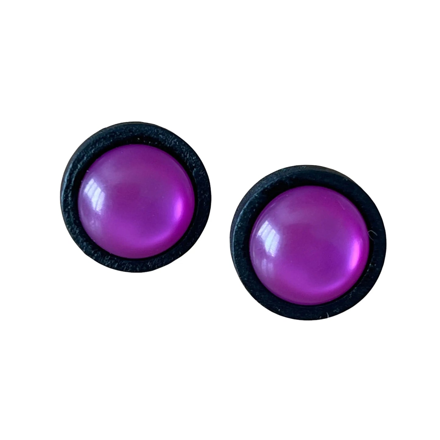 Pair of purple round earrings with black borders on a white background