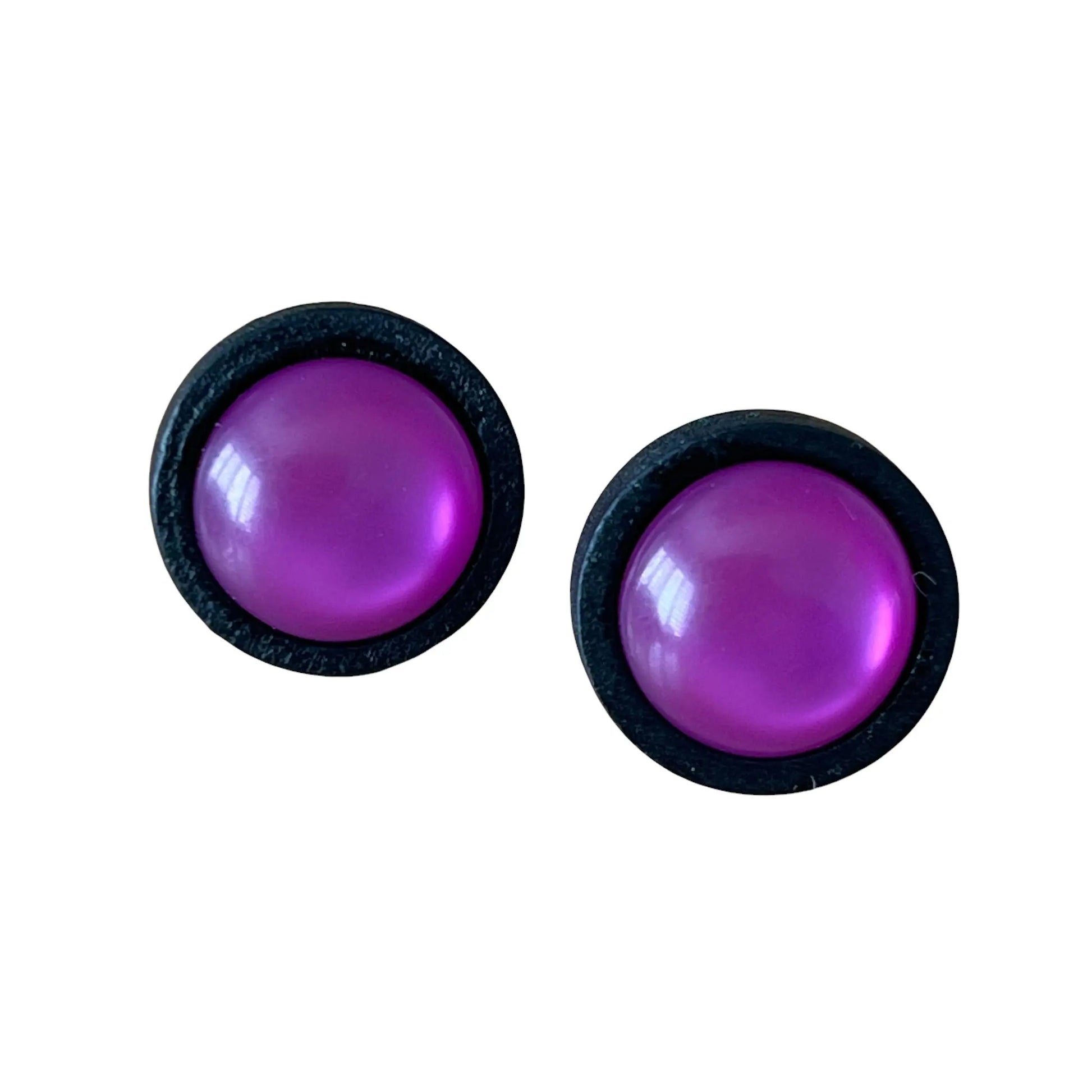 Pair of purple round earrings with black borders on a white background