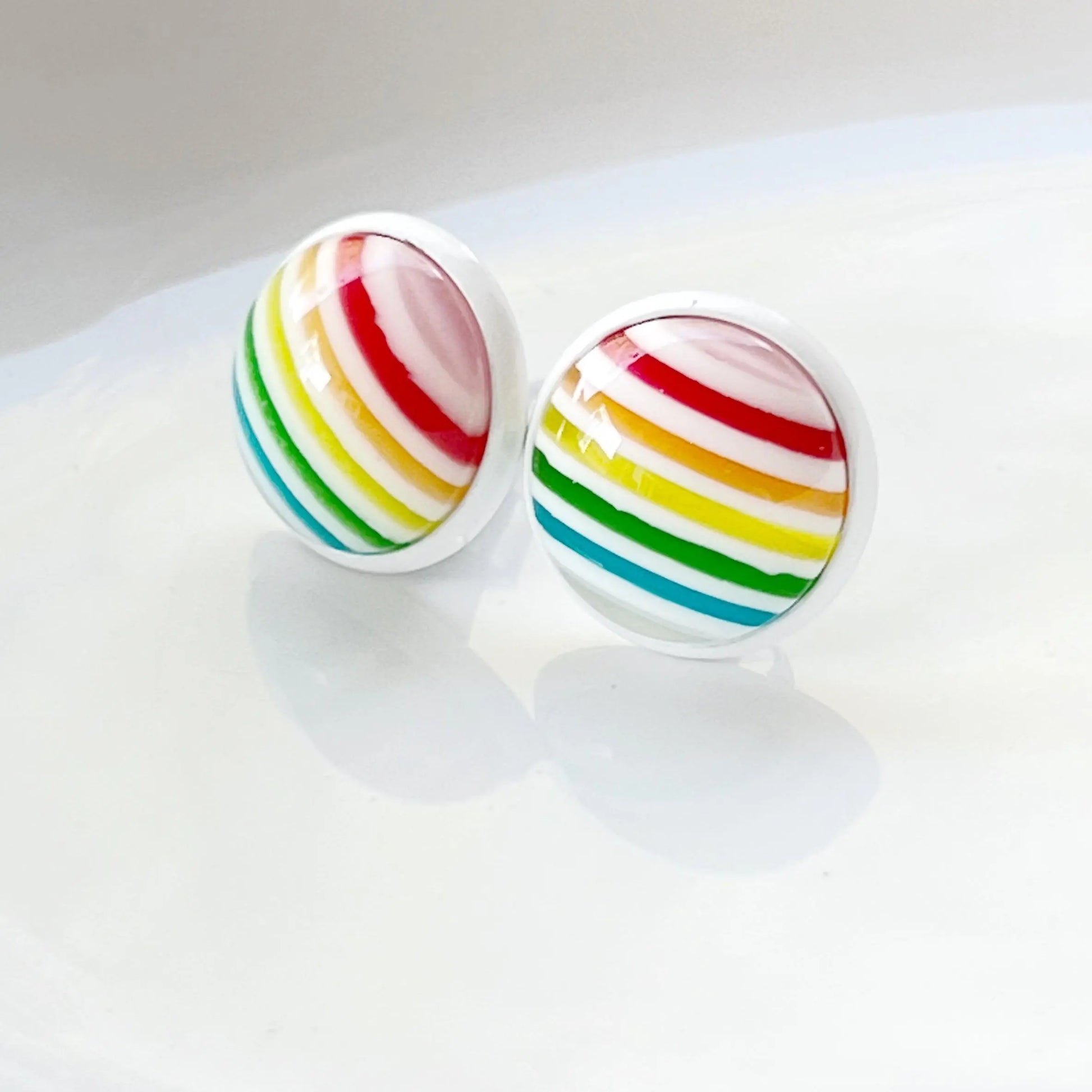Pair of rainbow striped earrings on a white background