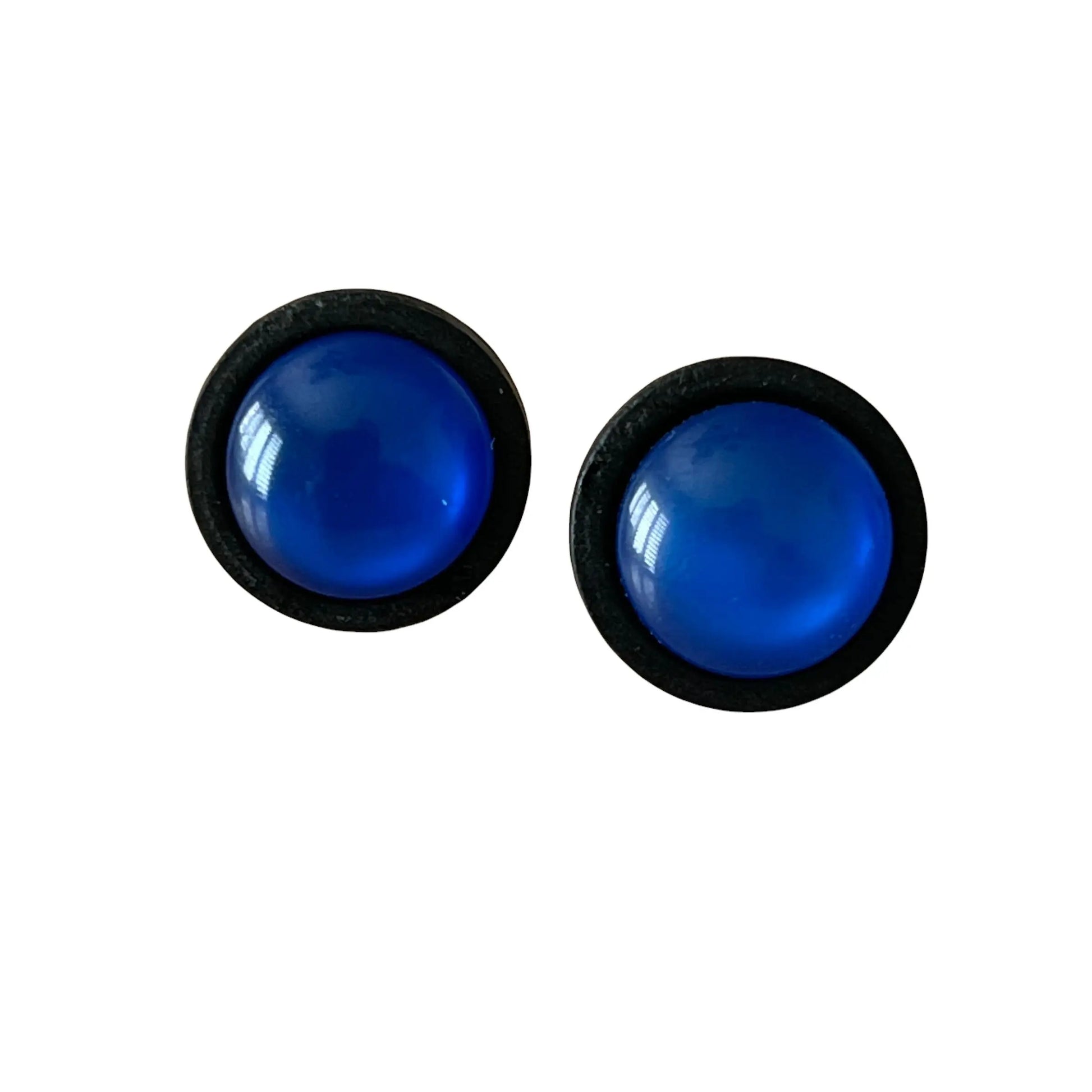 Pair of blue circular earrings with black rims on a white background