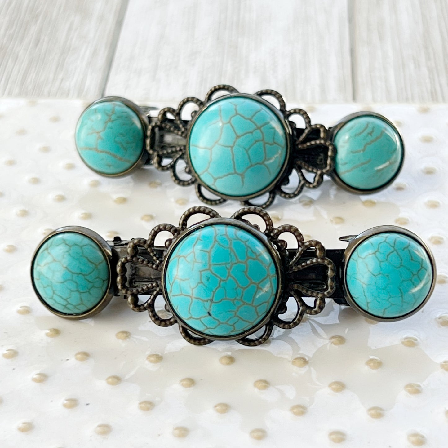 Turquoise Stone Hair Barrettes – on textured glass display 