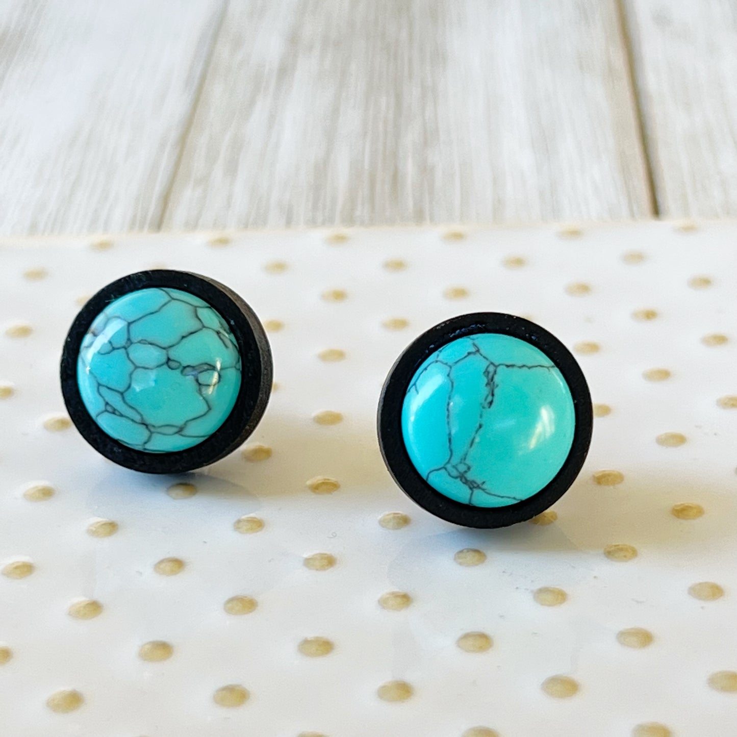 Turquoise Black Wood Stud Earrings on glass tray display 
