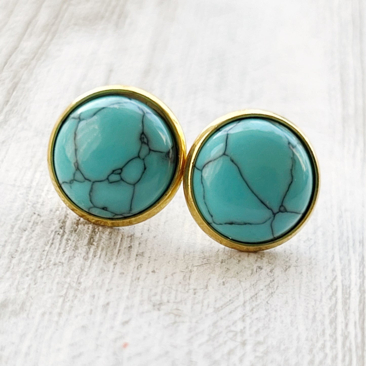 Round turquoise gold stud earrings close-up view