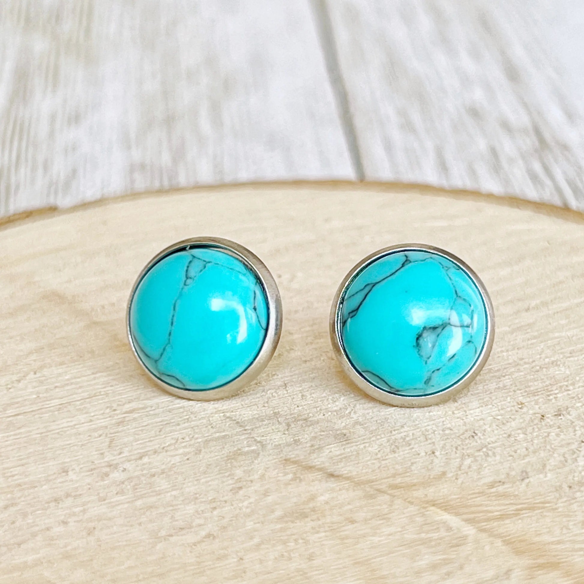 Boho Turquoise 12mm Silver Stud Earrings on wood slice