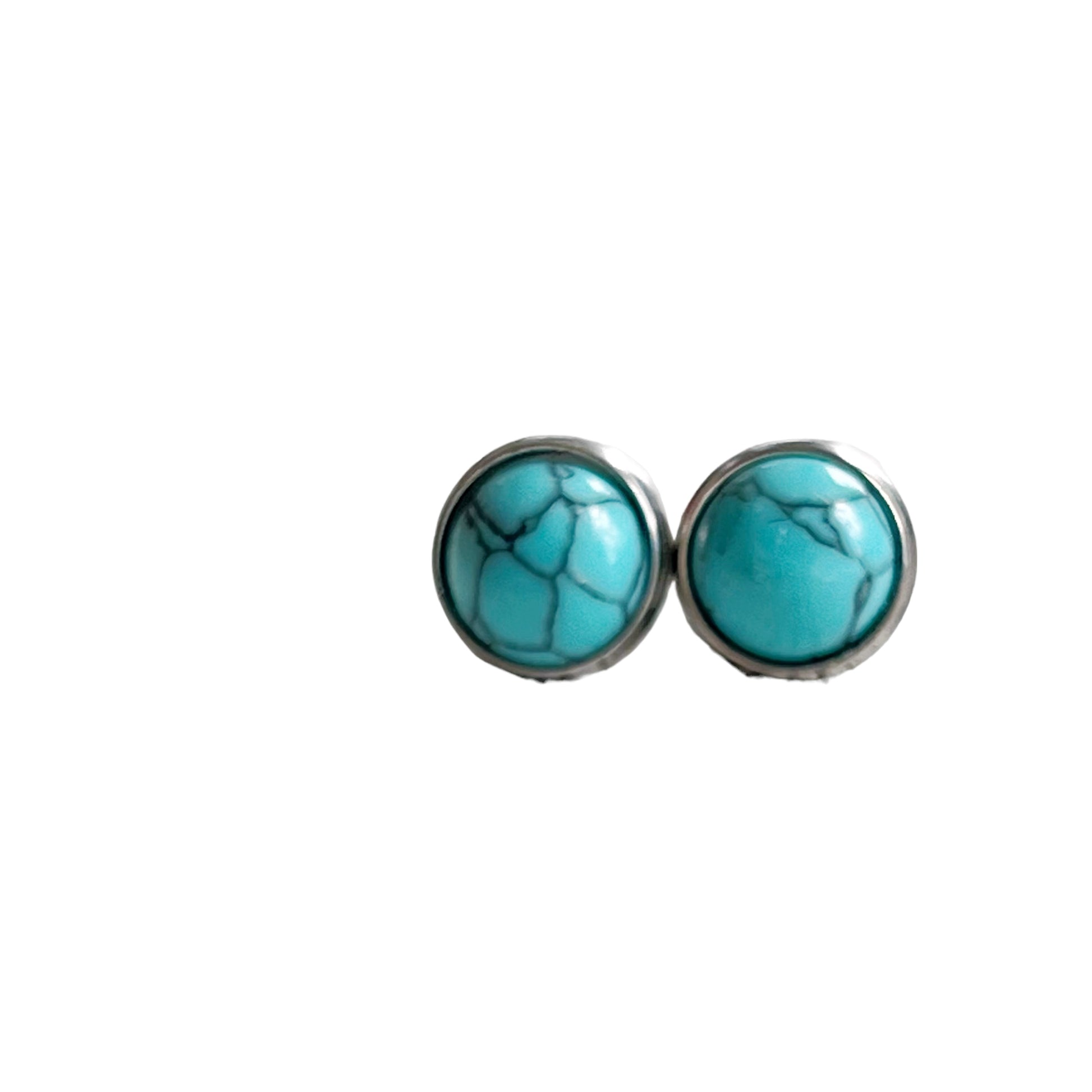 Round turquoise stud earrings in a silver-tone setting displayed on a white background