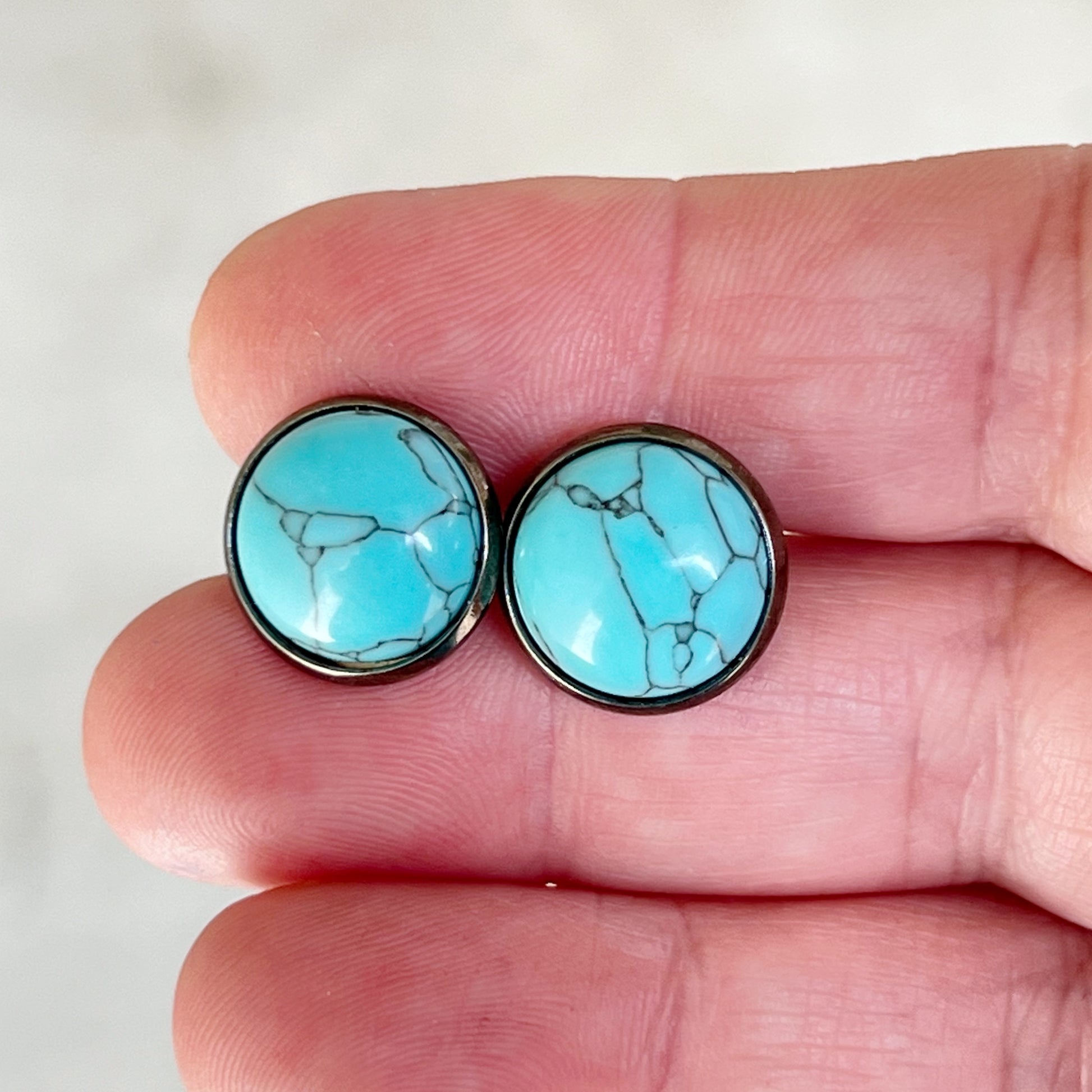 Turquoise 12mm Stud Earrings in hand for scale
