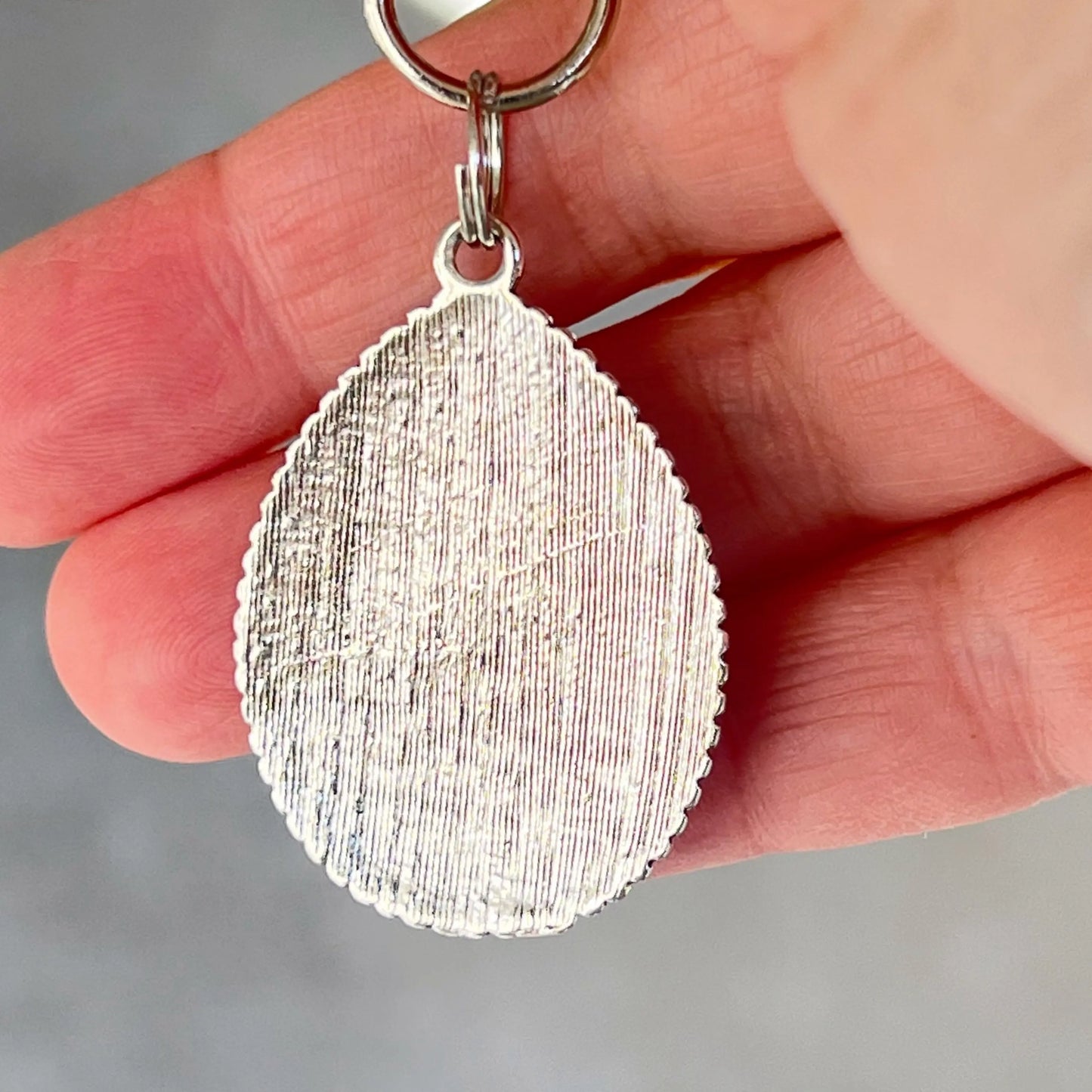 Silver western handbag charm with ornate medallion detail and faux turquoise accent back side 