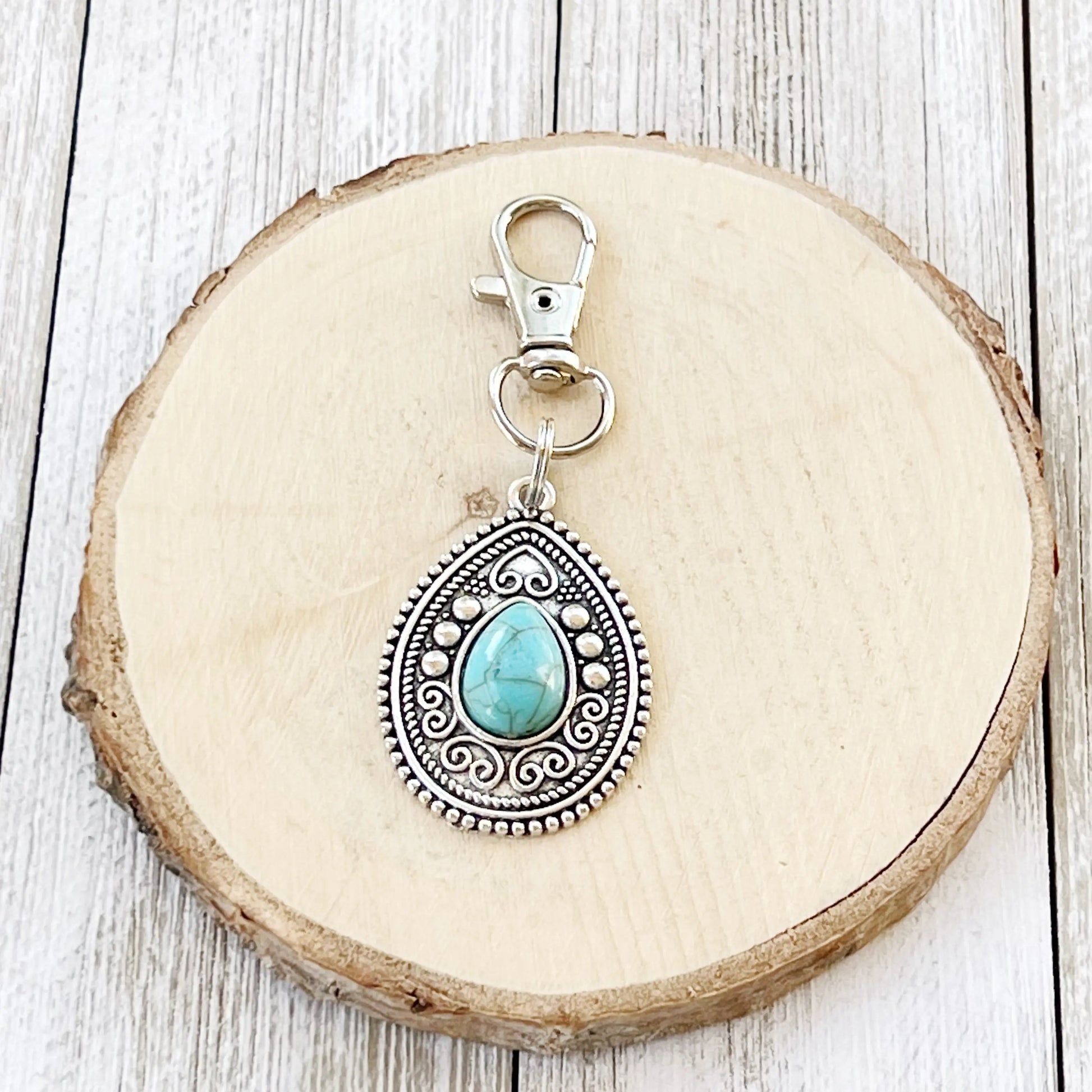 Turquoise Western Zipper Pull Handbag Keychain Charm - on wood slice display 