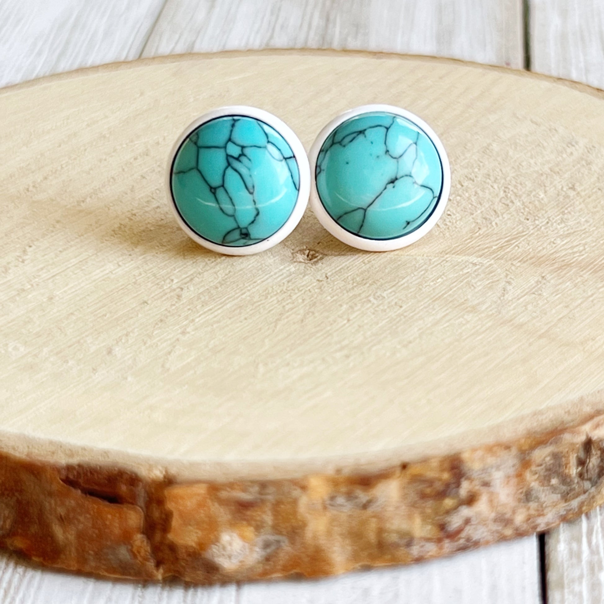 Turquoise 12mm White Stud Earrings on wood slice display 