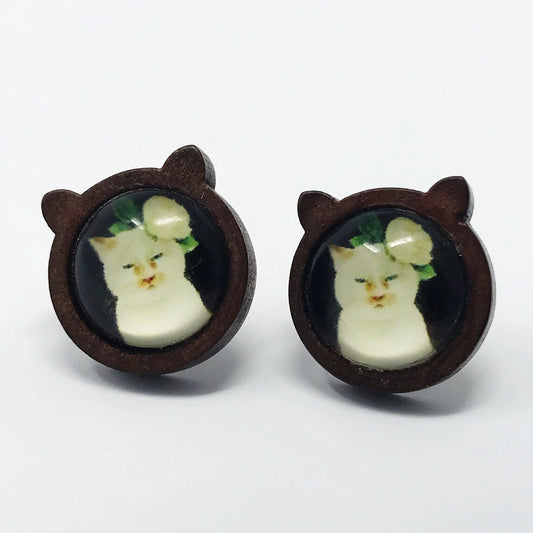 Pair of earrings with cat face design on a white background