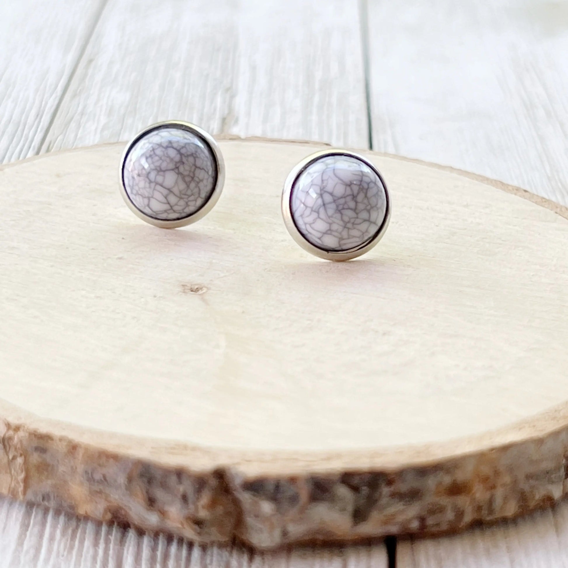 White Stone Stud Earrings - front view on wood background 